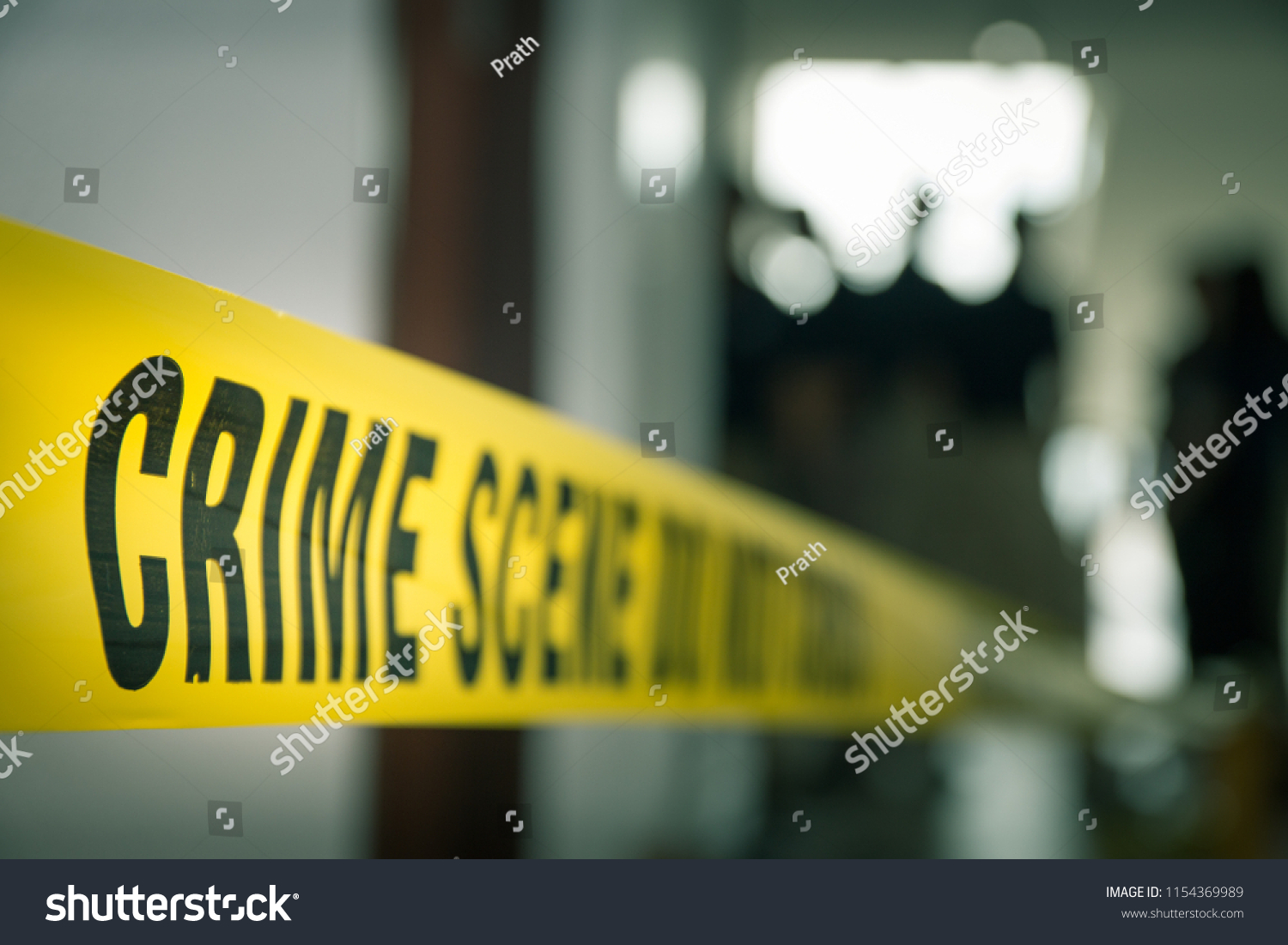 crime concept by police line tape with blurred forensic law enforcement background in cinematic tone and copy space #1154369989