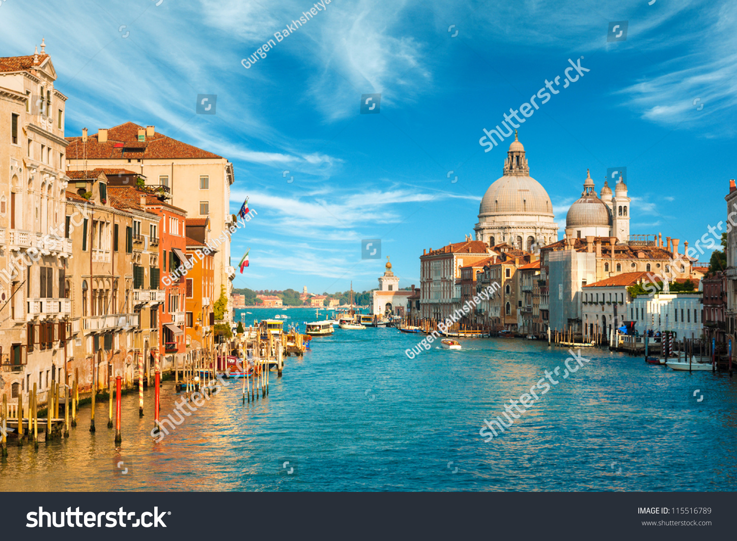 Gorgeous view of the Grand Canal and Basilica Santa Maria della Salute during sunset with interesting clouds, Venice, Italy #115516789
