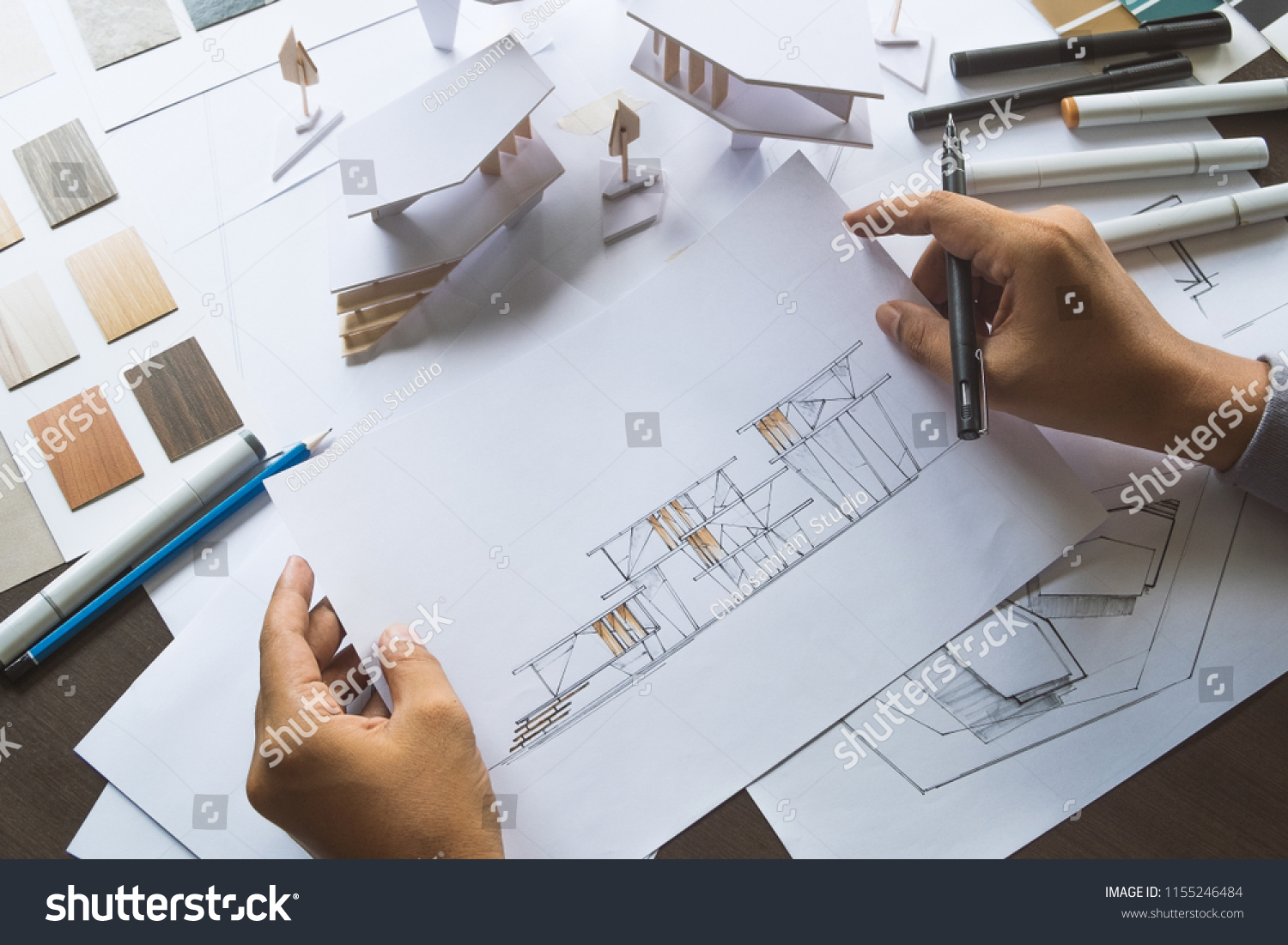 architect design working drawing sketch plans blueprints and making architectural construction model in architect studio #1155246484