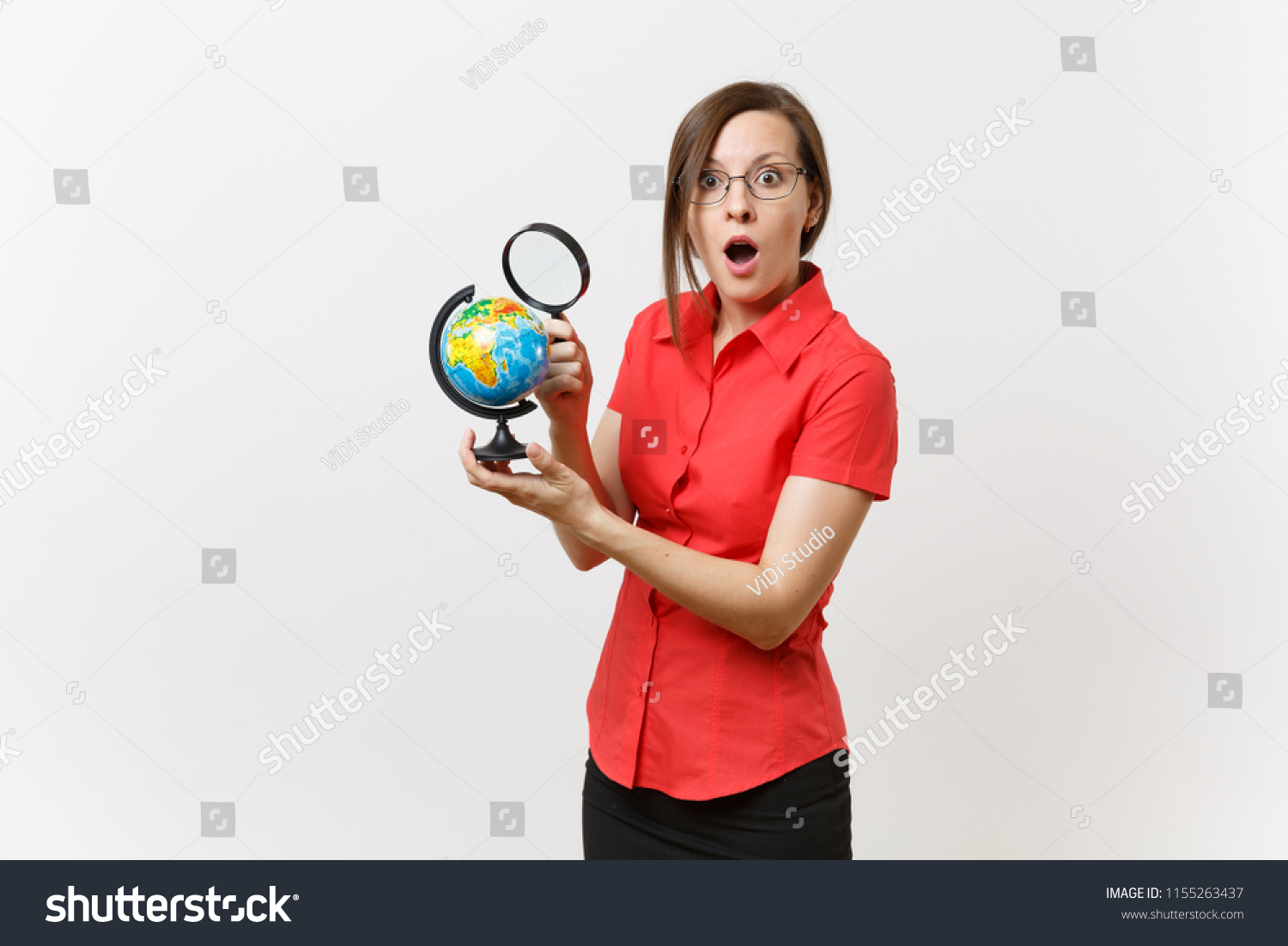 Portrait of business teacher woman in red shirt holding and looking through magnifying glass on globe isolated on white background. Education teaching in high school university concept. Copy space #1155263437
