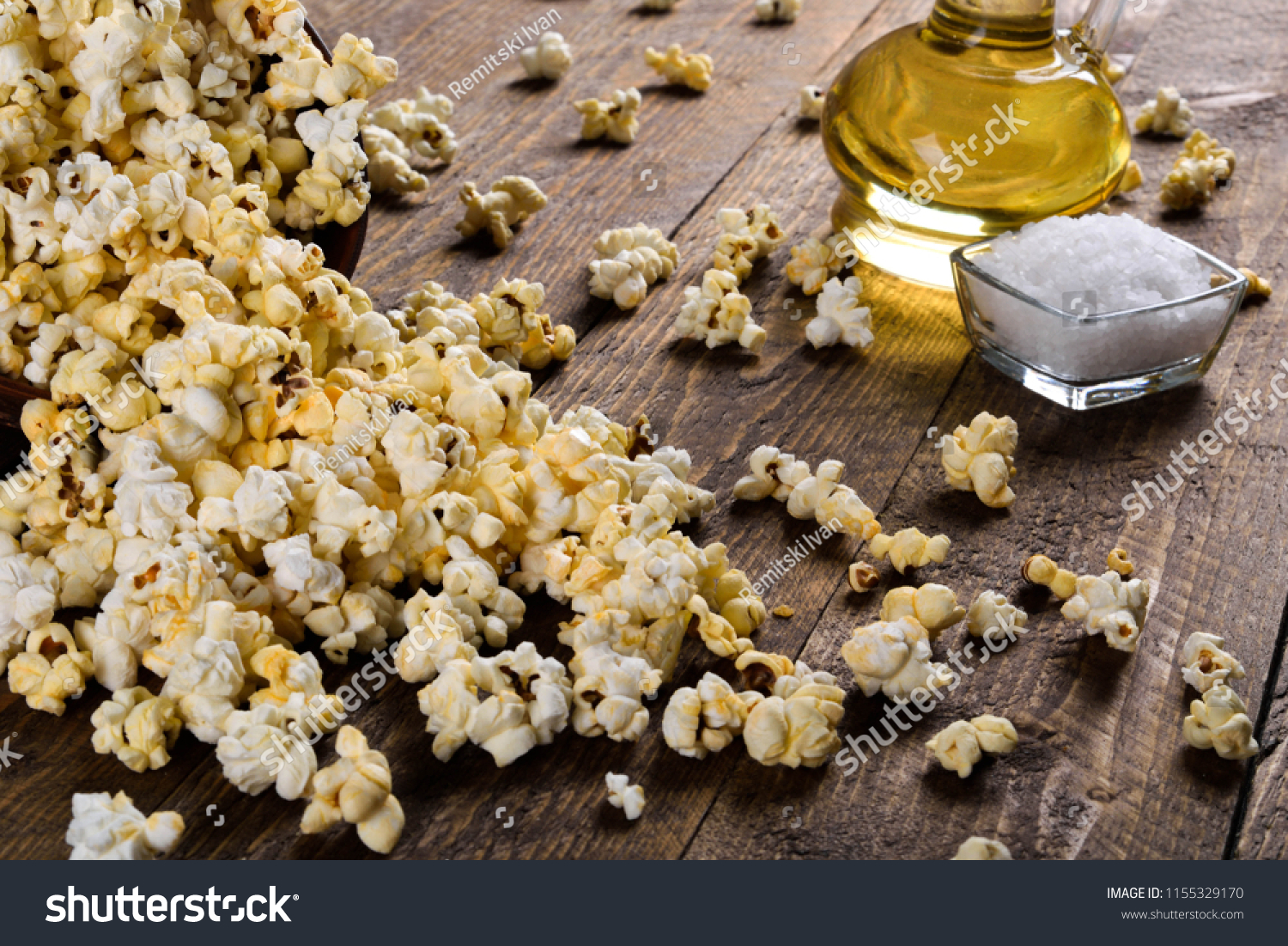 Air salty popcorn.A bowl of popcorn on a wooden table.Salt popcorn on the wooden background . 
With space for text.Top view.popcorn texture.Chees .
 #1155329170
