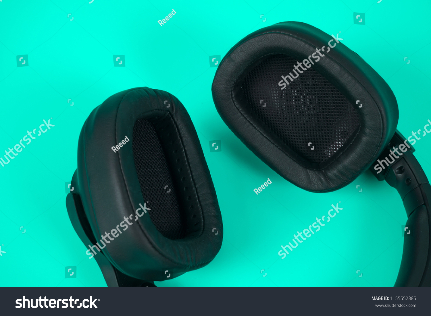 Black Headphons on aqua color background with copyspace. #1155552385