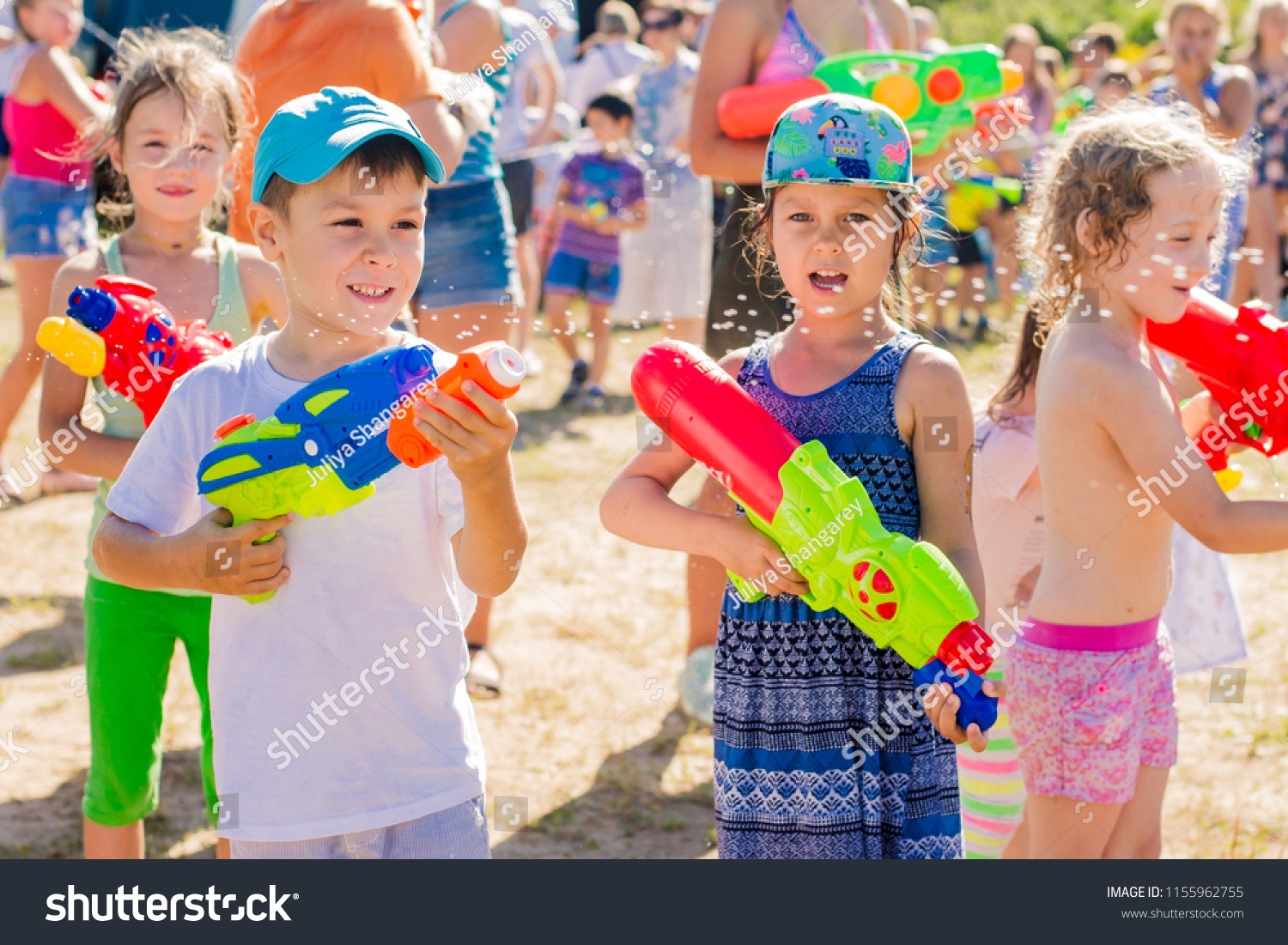 Russia. Moscow. August 11, 2018 Children playing outdoors with water cannons on a beautiful sunny day. Water battle, water game battle #1155962755
