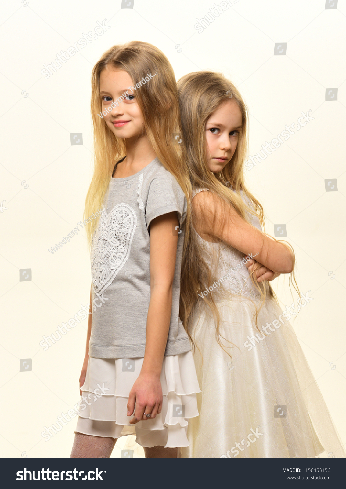 kid fashion. two small girls follow kid fashion. kid fashion with pretty sisters. kid fashion for girls in fashionable clothes. #1156453156