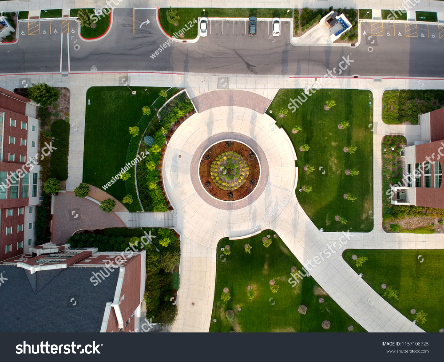 A roundabout with vegetation and structures. #1157108725