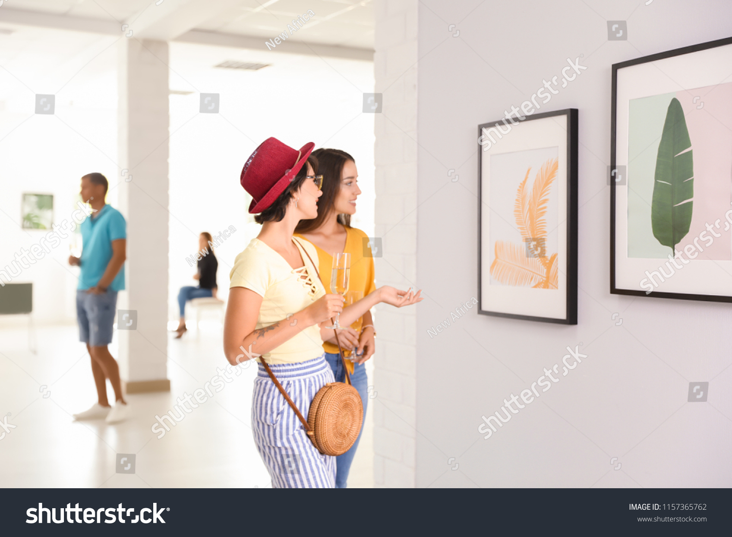 Young women at exhibition in art gallery #1157365762