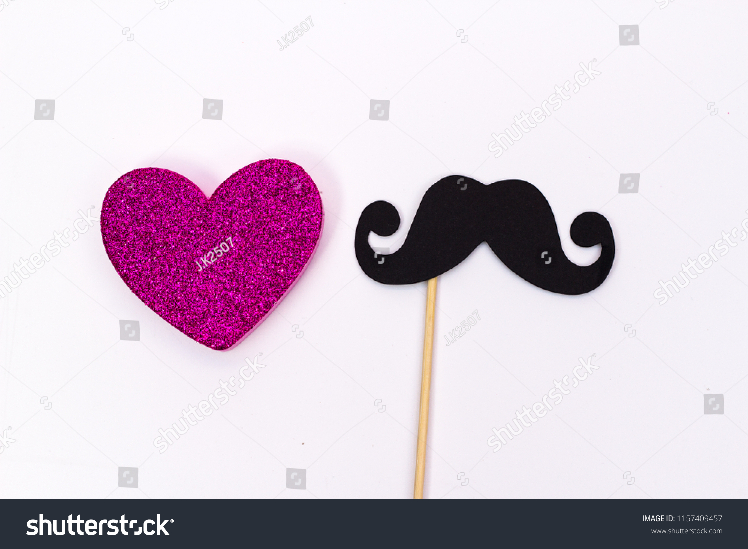 paper mustache on a stick and a pink heart on white background #1157409457