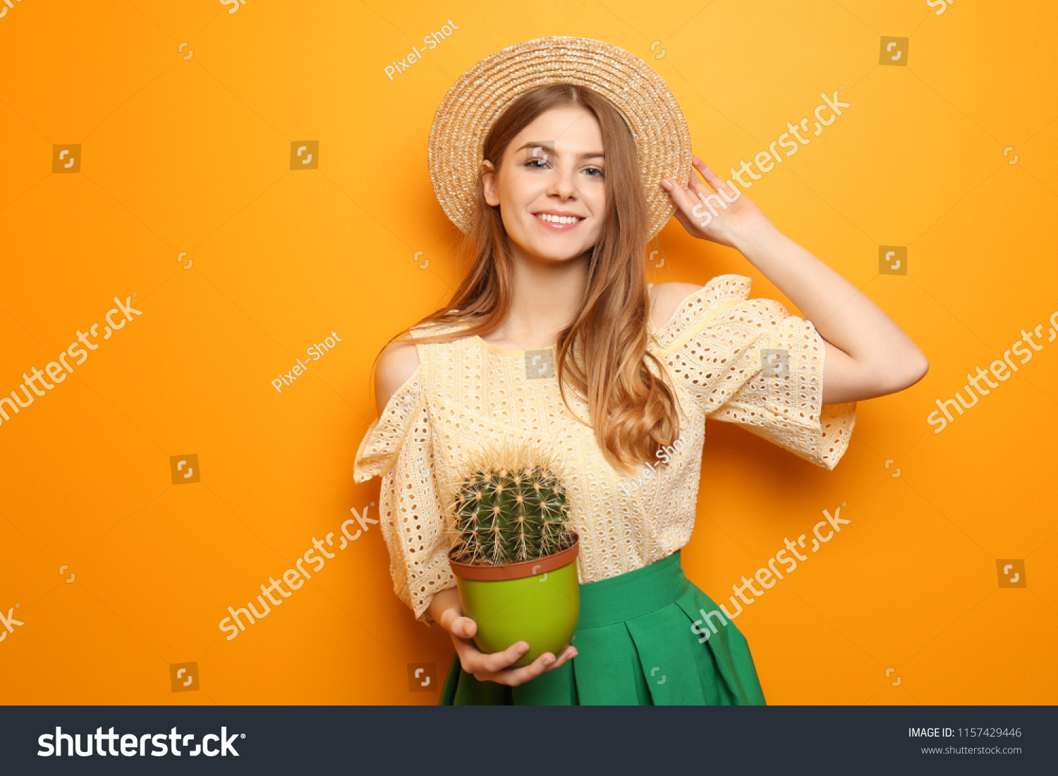 Beautiful young woman with cactus on color background #1157429446