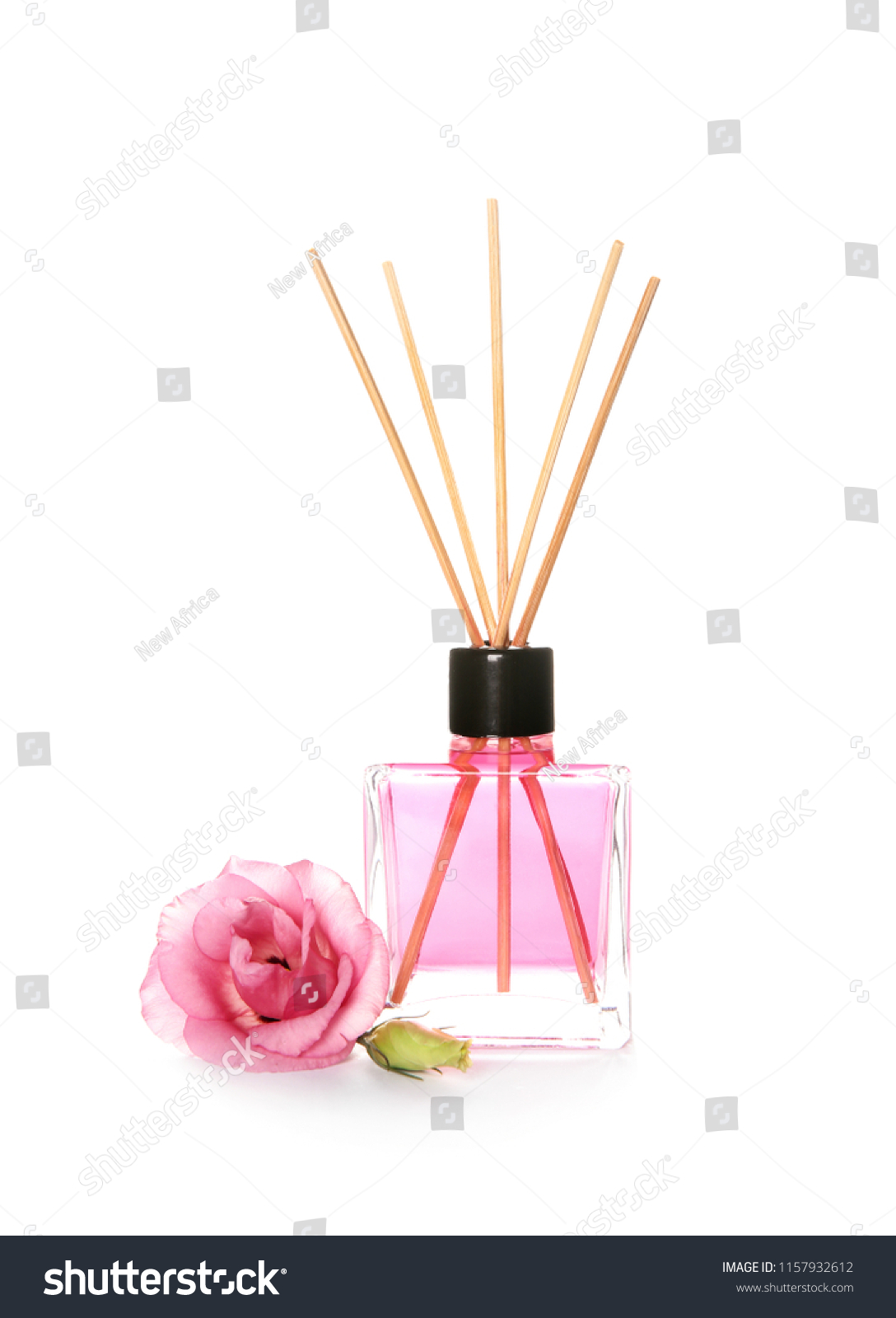 Aromatic reed air freshener and rose on white background #1157932612