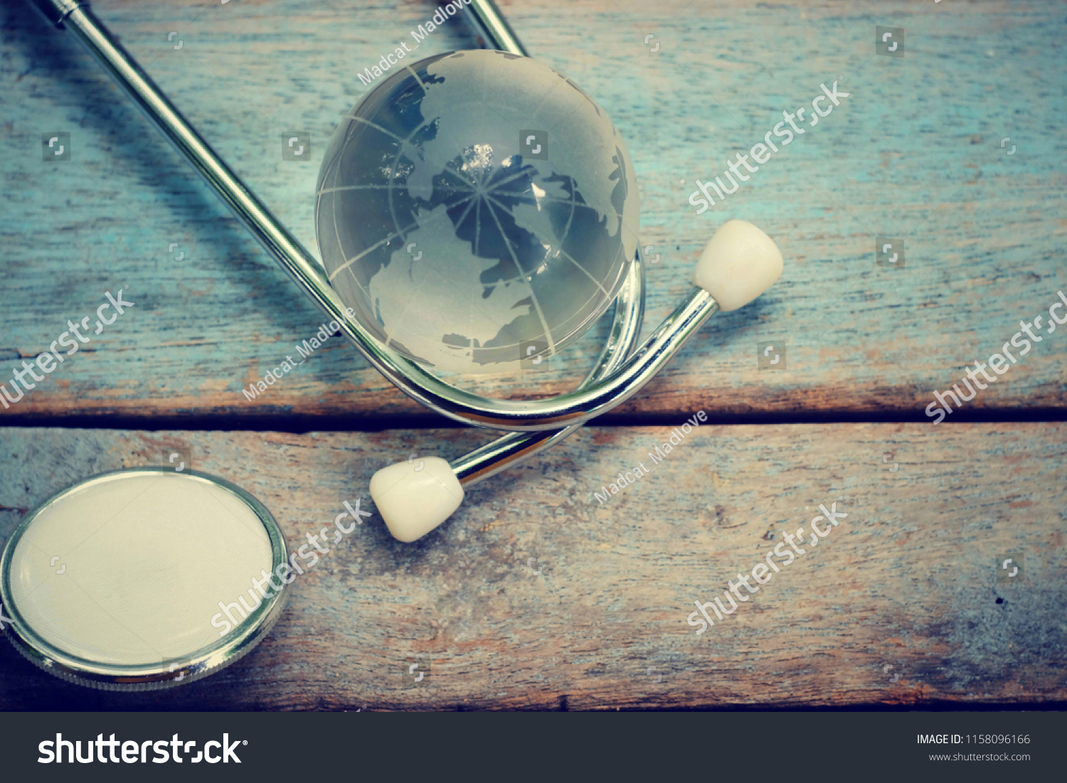 close up glass global and stethoscope on old wood table, world health day, medical and healthcare technology concept, vintage tone #1158096166