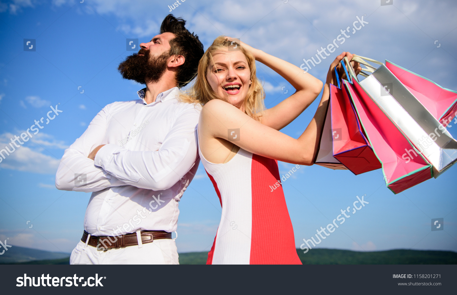 Hipster confident stan back to back birthday girl. Generous gift. Girl hold bunch shopping bags gifts birthday anniversary holiday. Generosity is important trait for man. He knows how make her happy. #1158201271