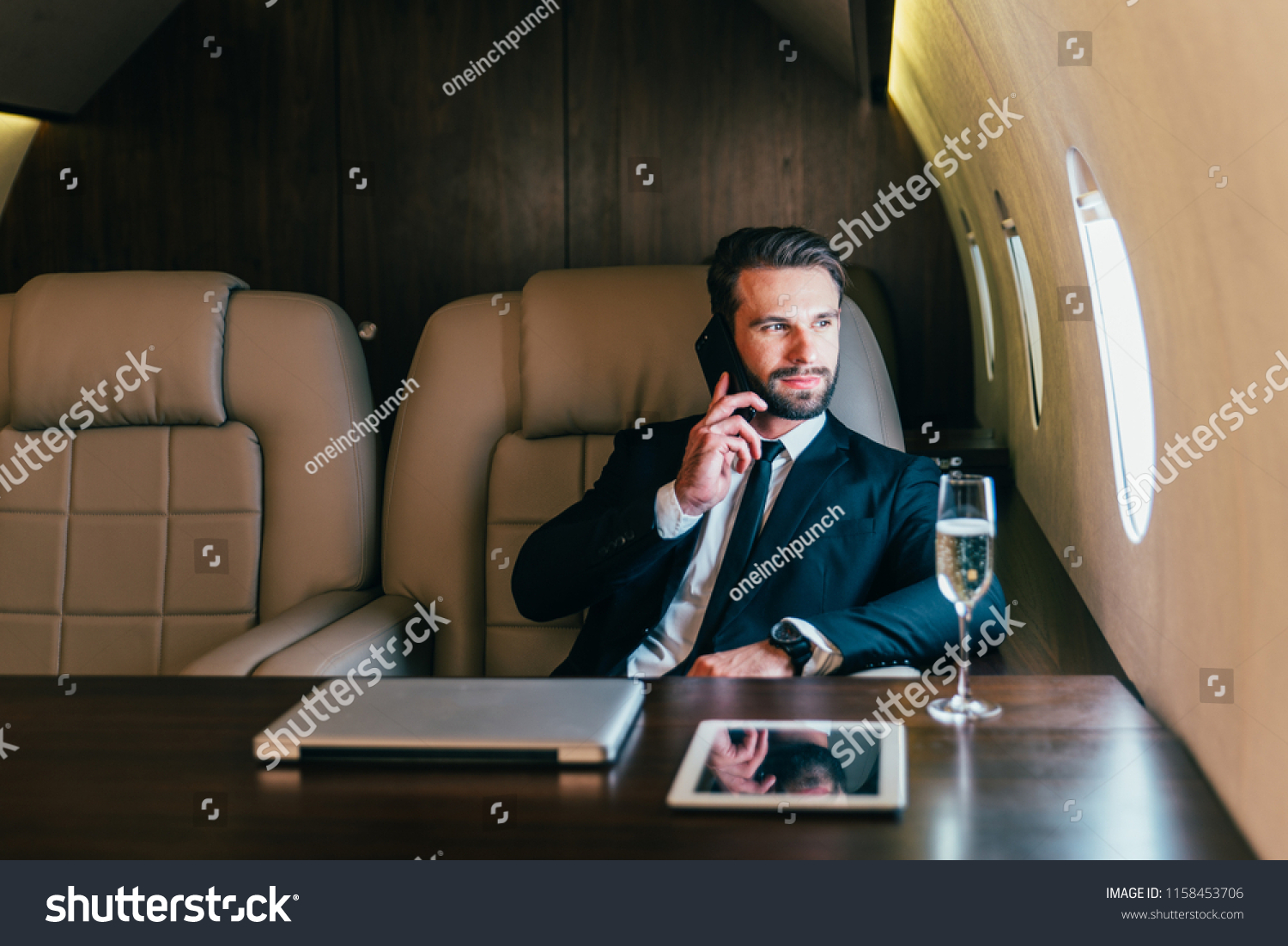 Businessman flying on his private jet #1158453706