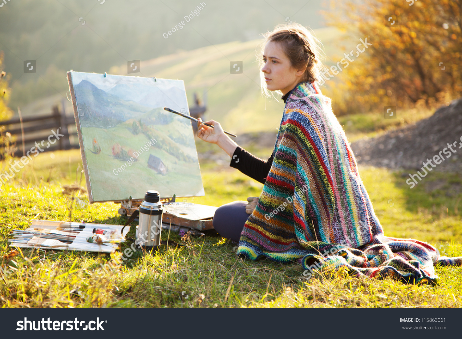 Young artist painting an autumn landscape #115863061