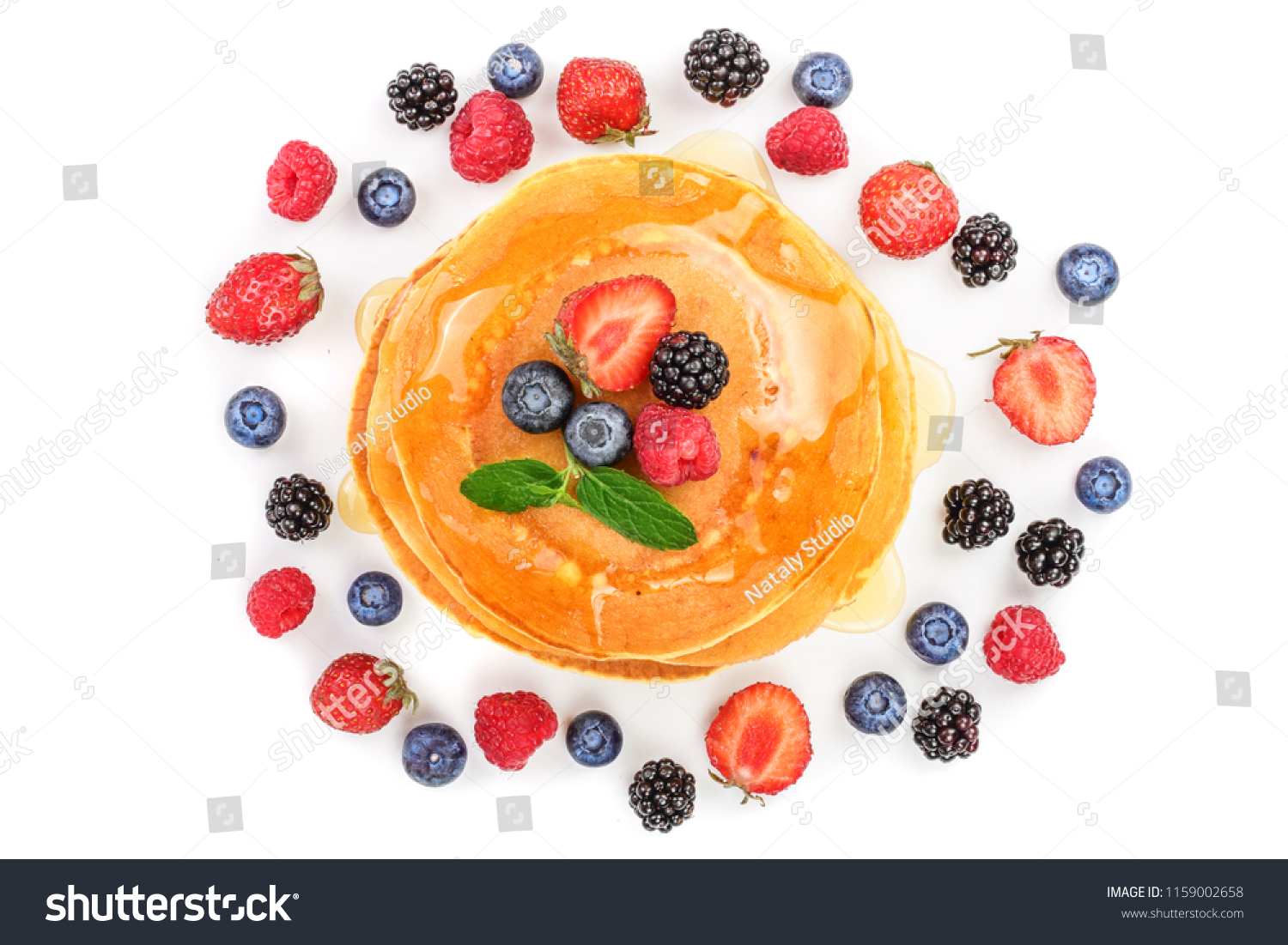 Pancakes stack with different berries isolated on white background. Top view. Flat lay #1159002658