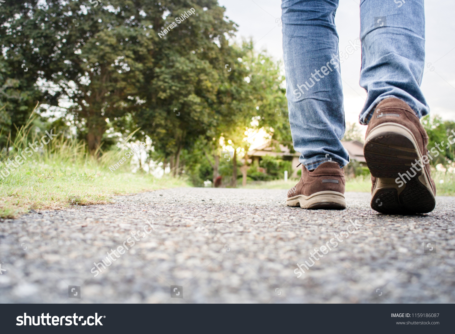 close up of boy shoes walking on the street in the evening #1159186087