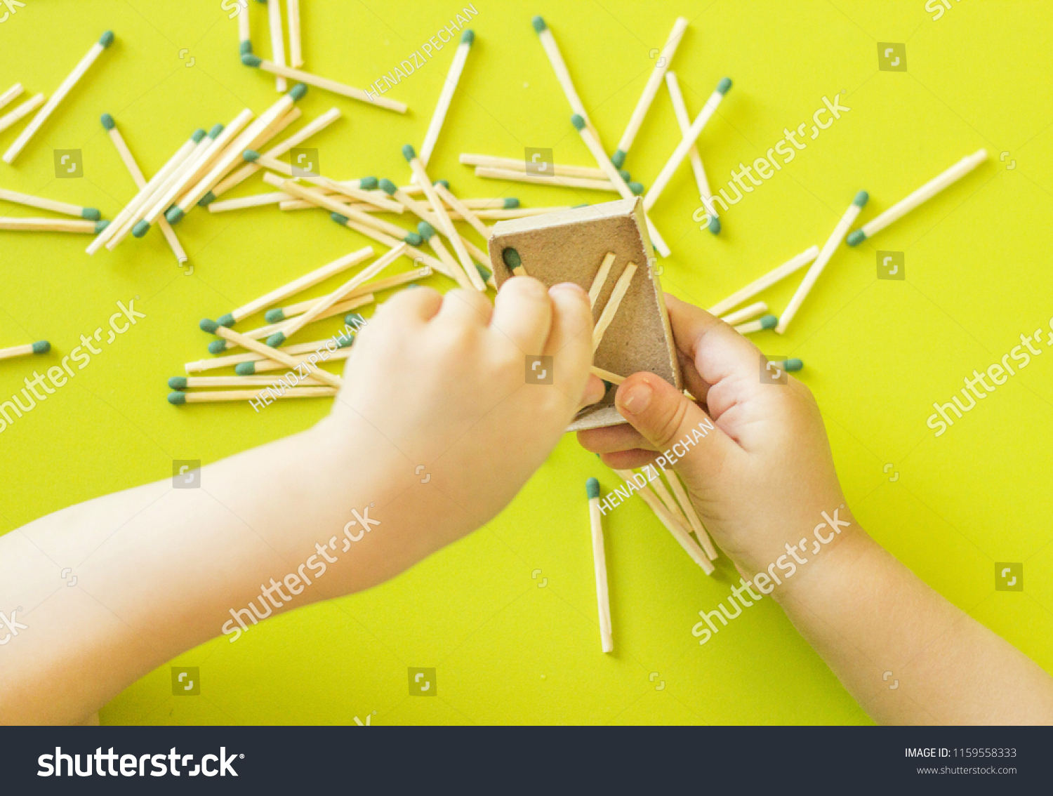 A small child plays with matches, matches matches into boxes, close-ups, fire, lucifer match, hand #1159558333