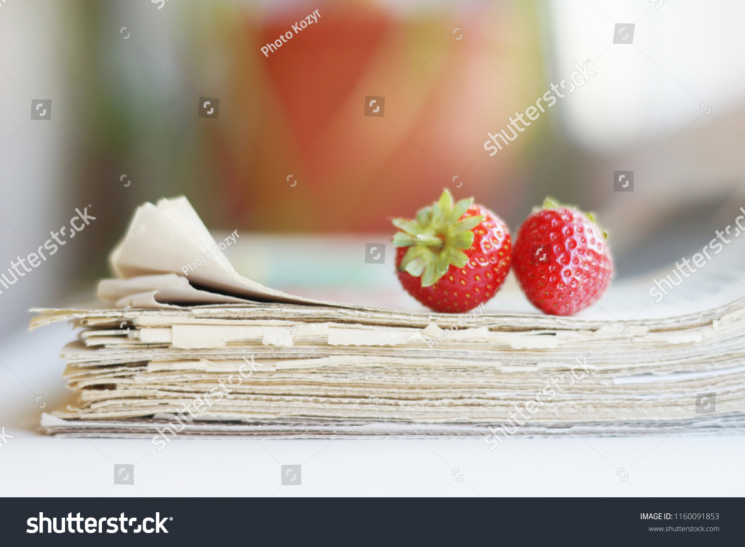 Stack of newspapers and strawberries. Daily journals with headlines and articles and fresh fruits. Concept for juicy news                                      #1160091853