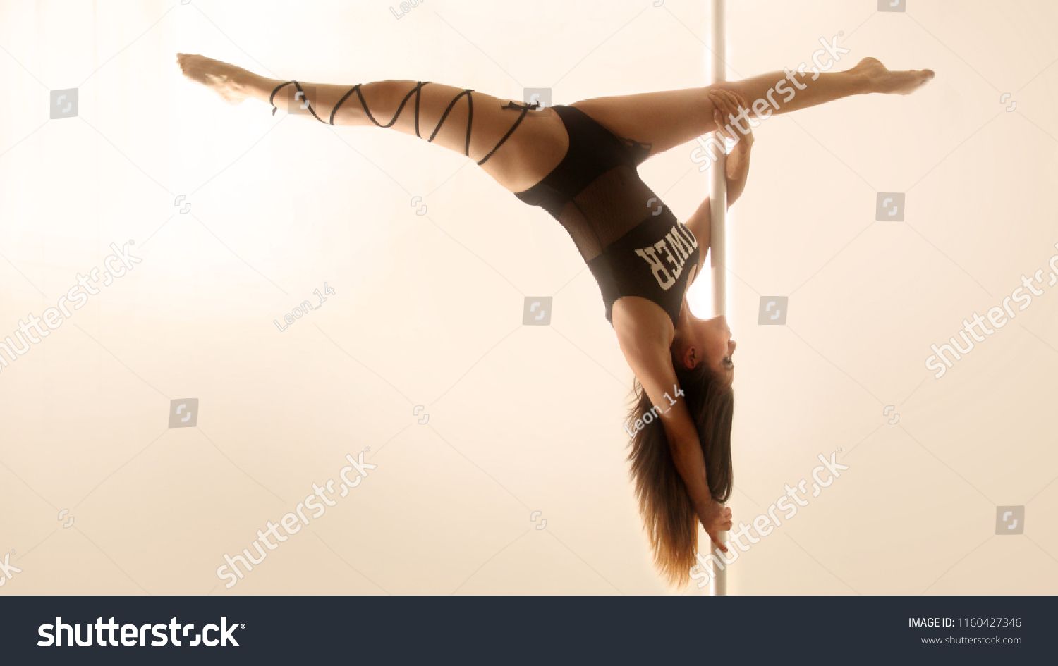AGUASCALIENTES - MAR 3, 2018: Pole dancer making a complex pose as part of her morning training #1160427346