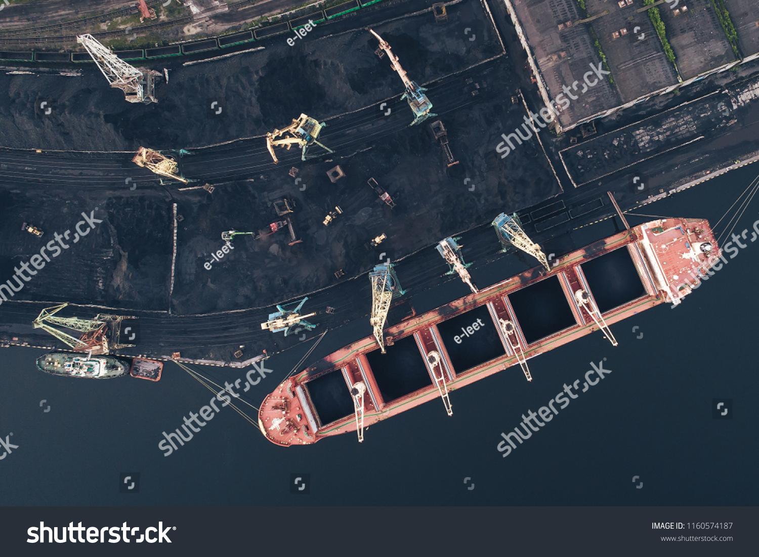 The Cargo Ship is in the Port Pier at the Loading of Coal at Sunset. Aerial View from Drone. Location Kandalaksha Town, Cola Peninsula, Russia #1160574187