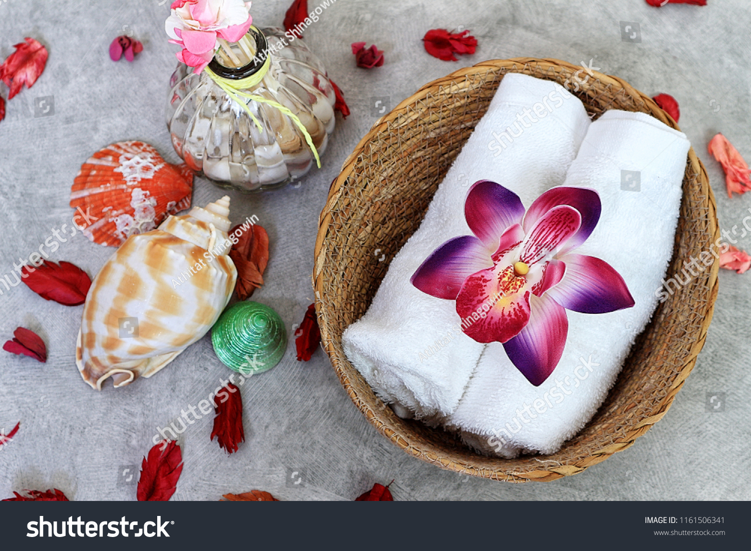 Orchid decorate on towel decorate with sea shell and dry rose, spa set. #1161506341