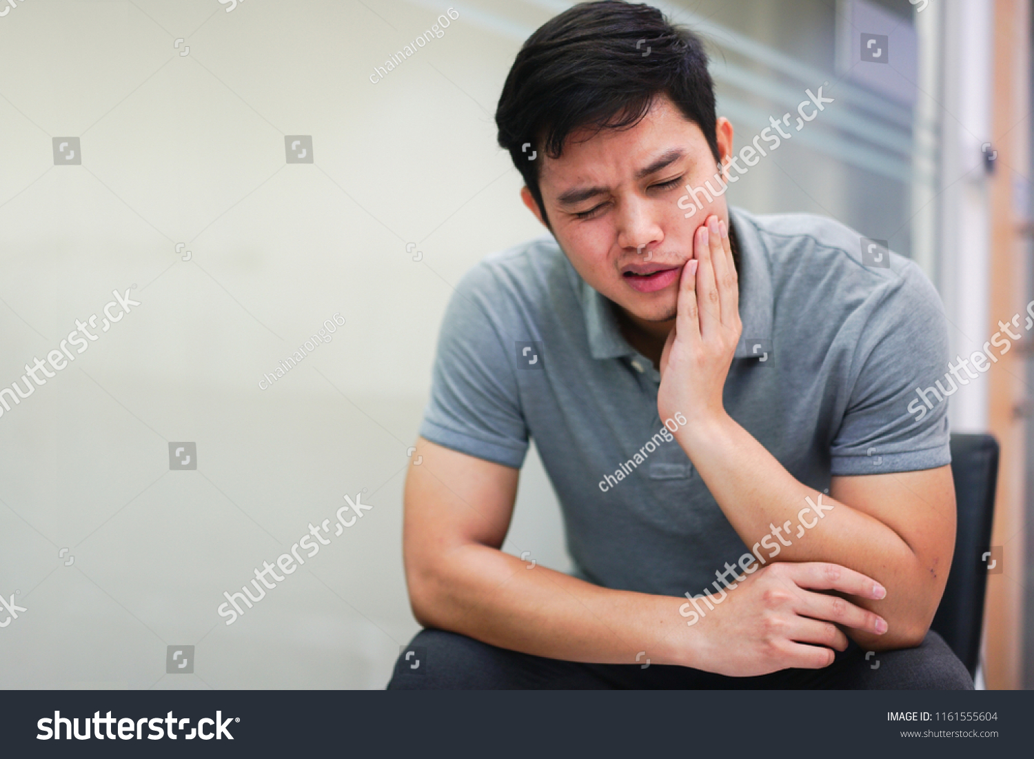 close up asian middle aged man feeling hurt from toothache symptom , unhealthy life concept #1161555604