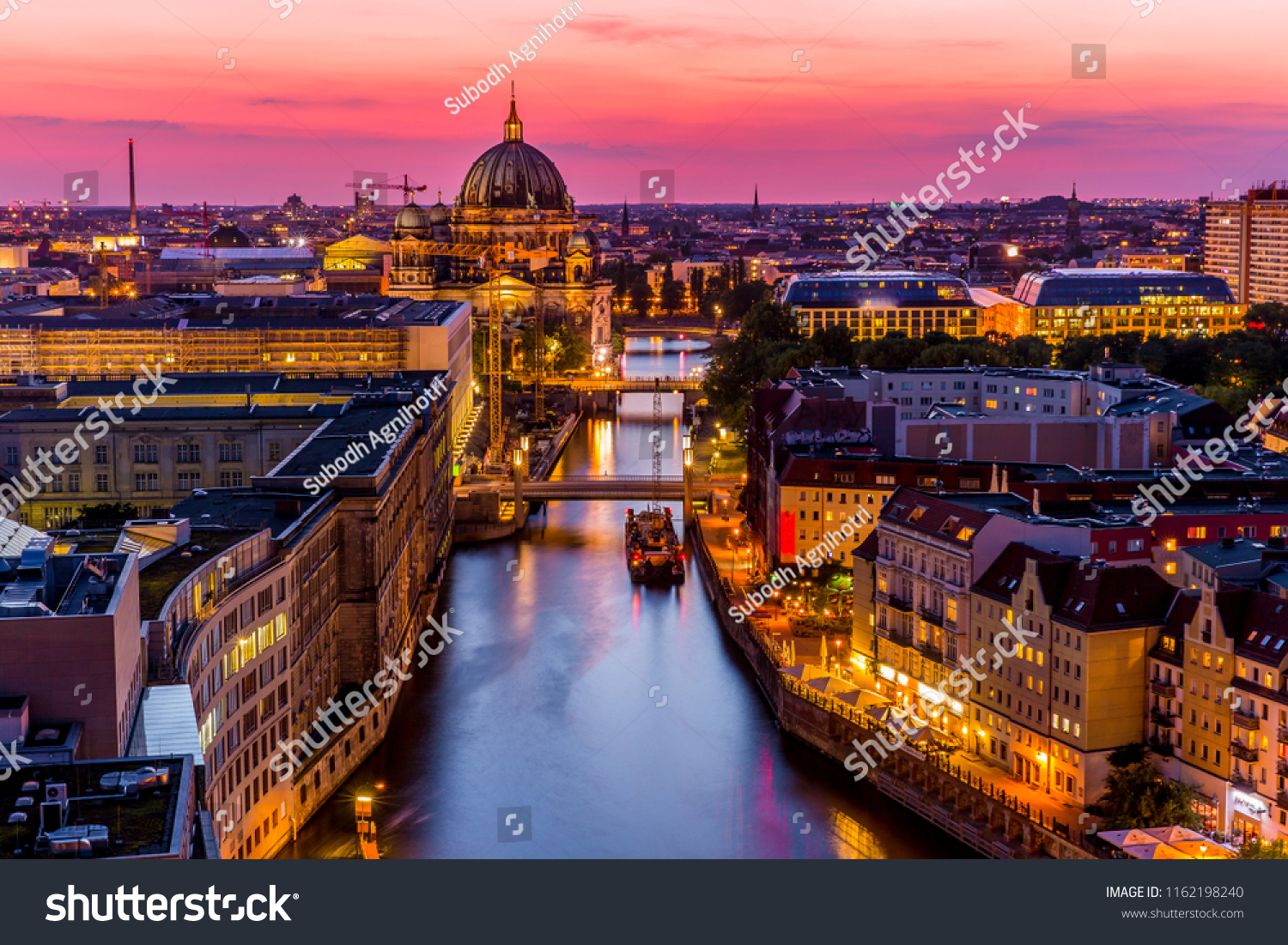 Panoromic  aerial view of Berlin skyline with famous TV tower and Spree river in beautiful post sunset twilight during blue hour at dusk with dramatic  colorful clouds , central Berlin Mitte, Germany #1162198240