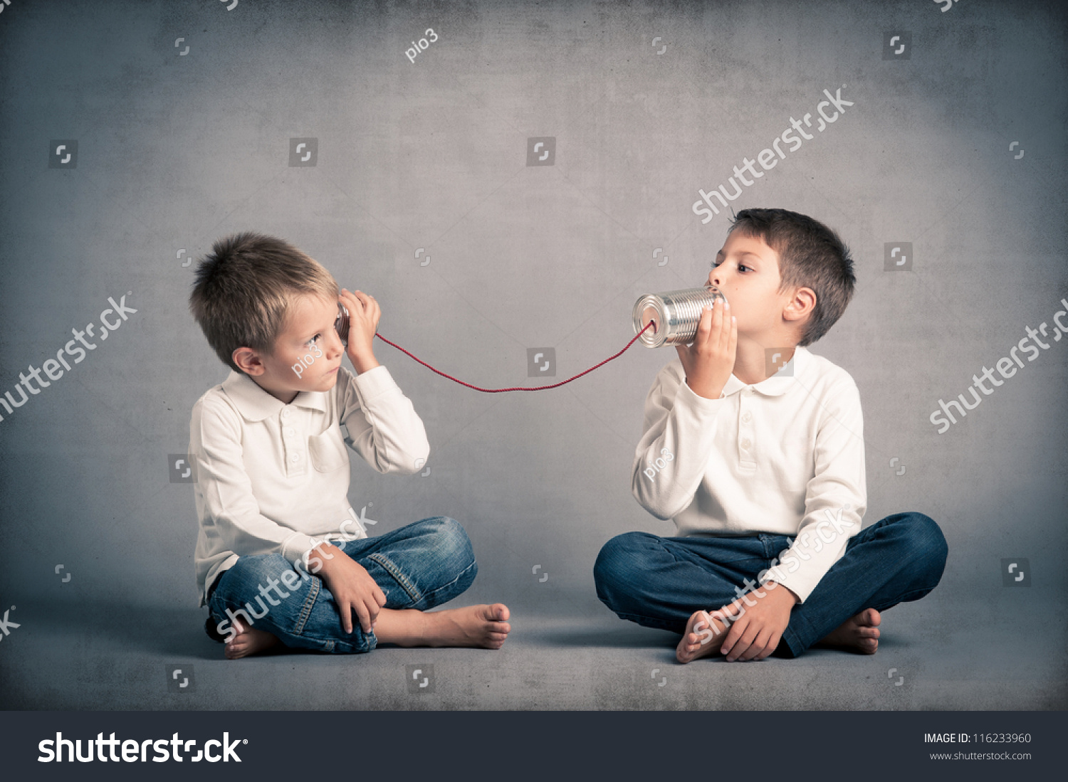 Young brothers talking with tin can telephone on grunge background. #116233960