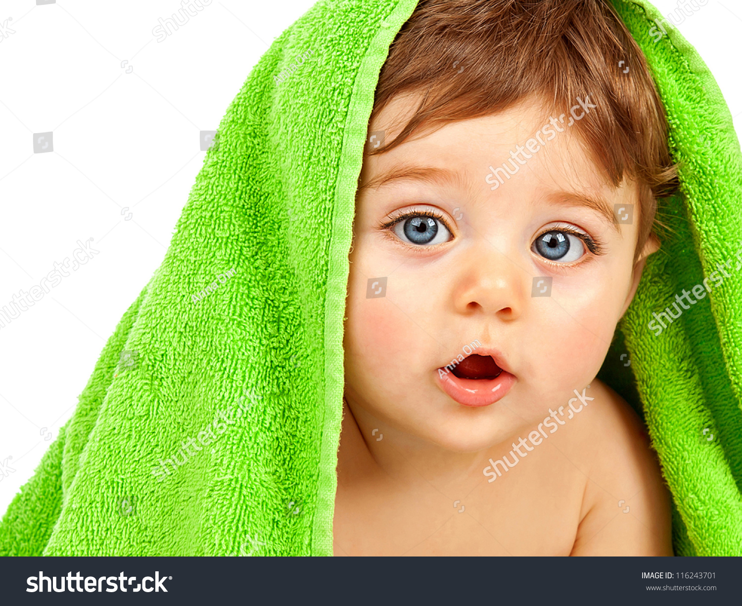 Image of cute baby boy covered with green towel isolated on white background, closeup portrait of cheerful kid with blue eyes, health care, pretty infant after bath, happy childhood, child's hygiene #116243701