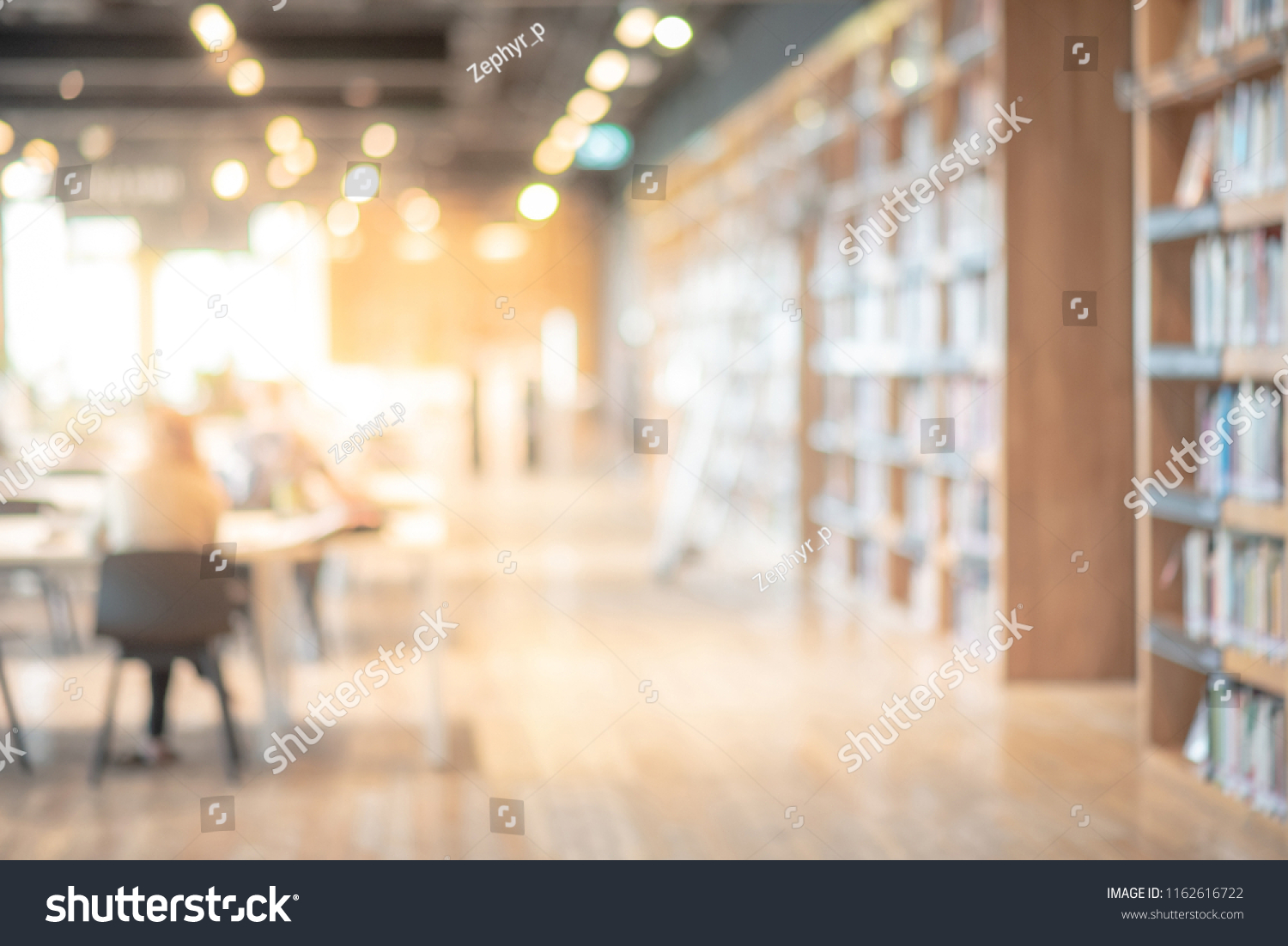 Abstract blurred empty college library interior space. Blurry classroom with bookshelves by defocused effect. use for background or backdrop in book shop business or education resources concepts #1162616722