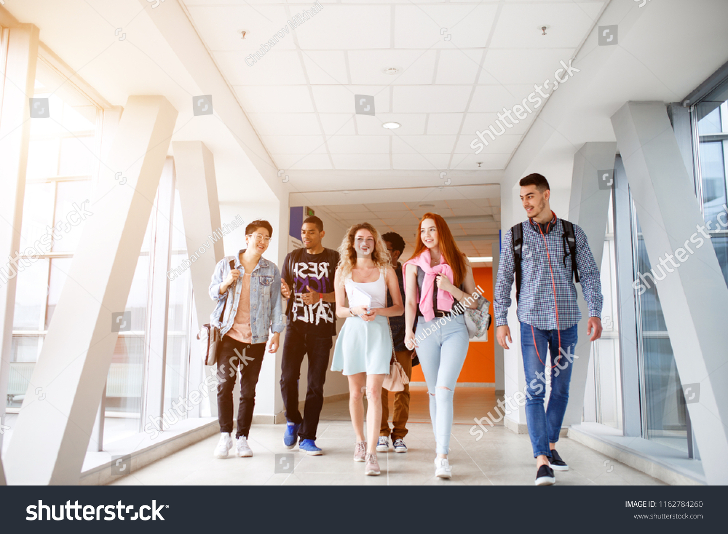 A group of young students from different countries go to classes. The photo illustrates education, College, school, or University. #1162784260