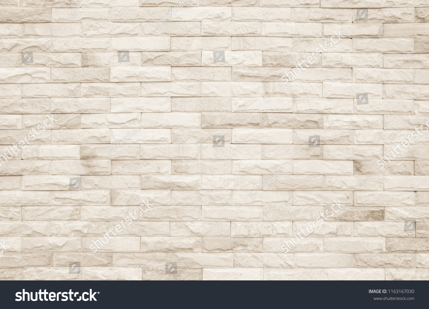 Cream and white brick wall texture background. Brickwork and stonework flooring backdrop interior design home style vintage old pattern clean with concrete uneven color beige bricks stack decoration. #1163167030