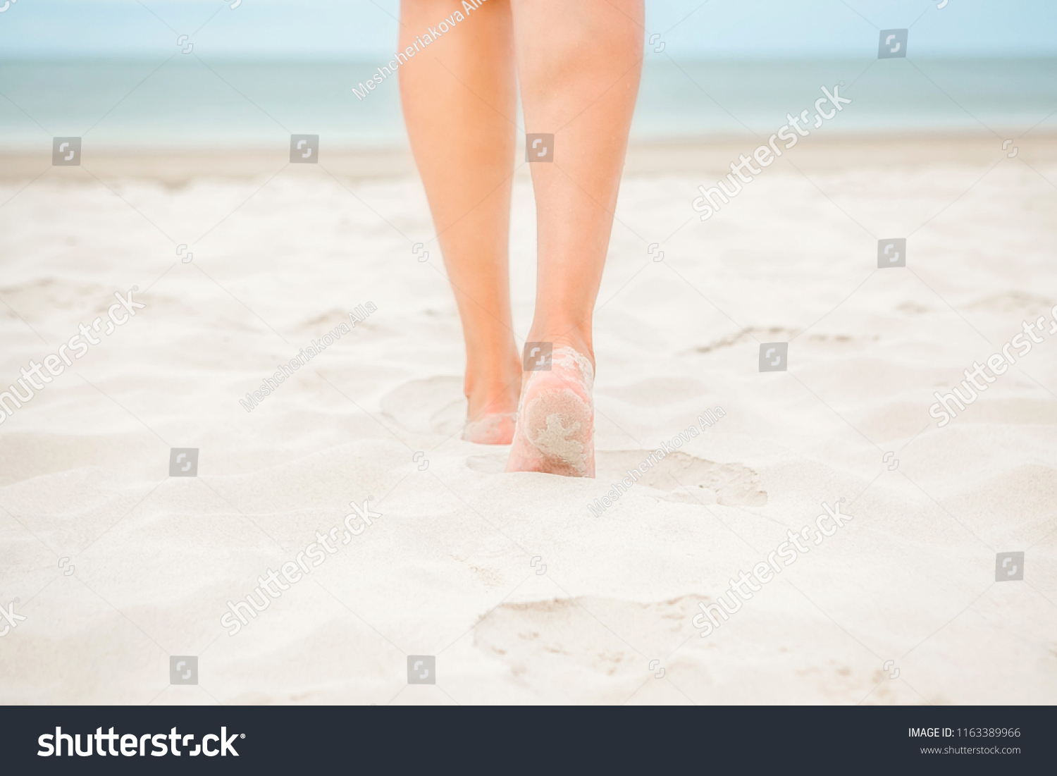 Vacation. Beach. Female feet on the sand. #1163389966