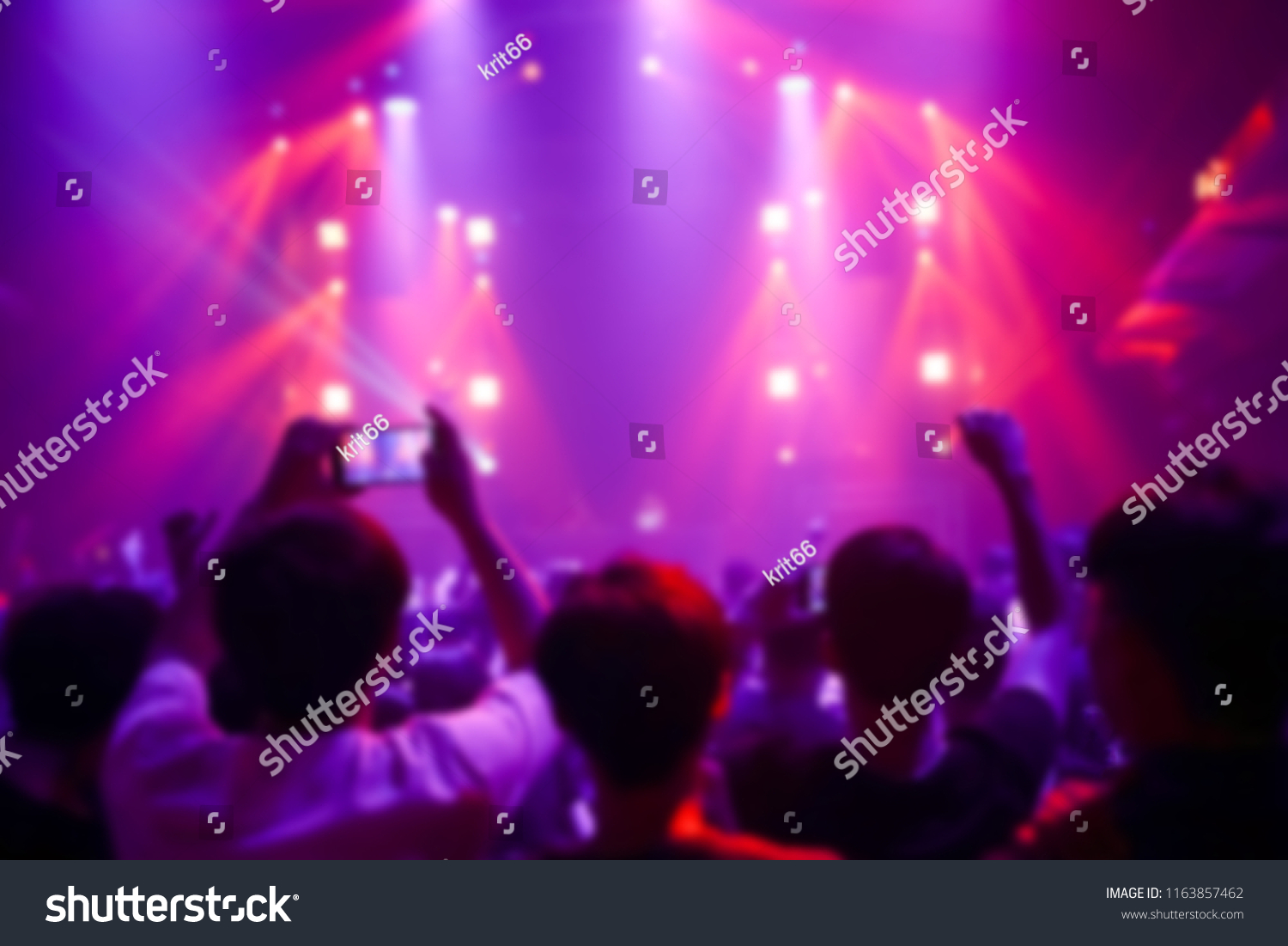 Effects blur Concert, disco dj party. People with hands up having fun #1163857462