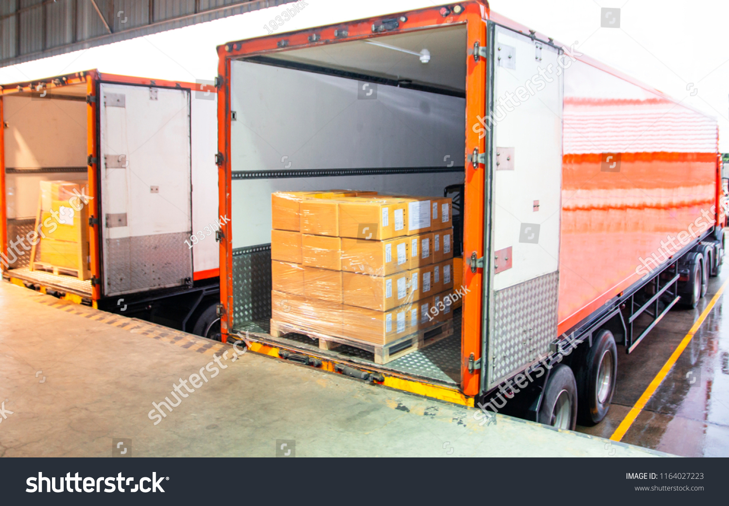 Cargo freight truck. Shipment, Delivery service. Logistics and transportation. Warehouse dock load pallet goods into shipping container truck. Stacked package boxes on pallet inside a truck. #1164027223