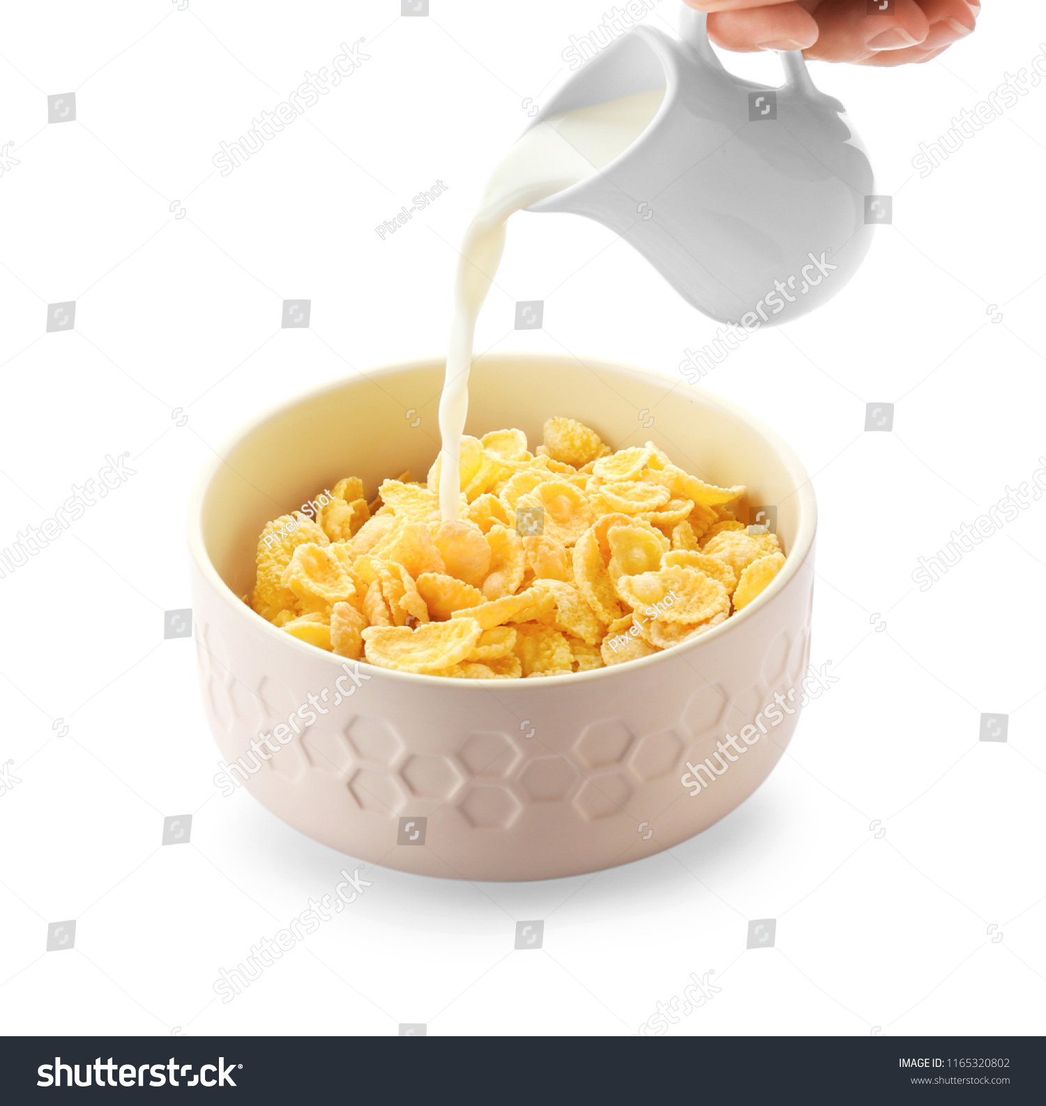 Pouring of milk into bowl with healthy cornflakes on white background #1165320802