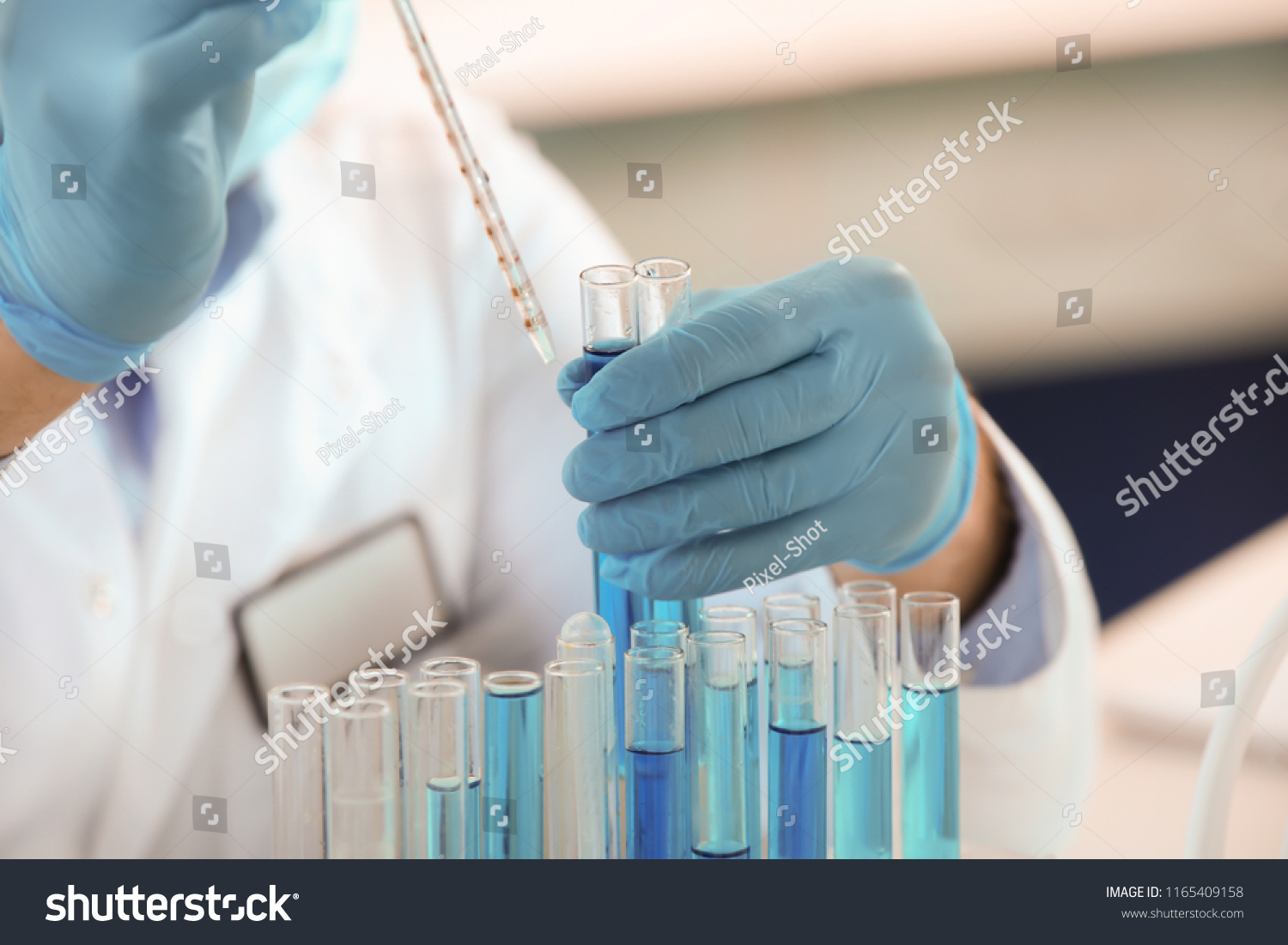 Scientist working with samples in test tubes, closeup #1165409158
