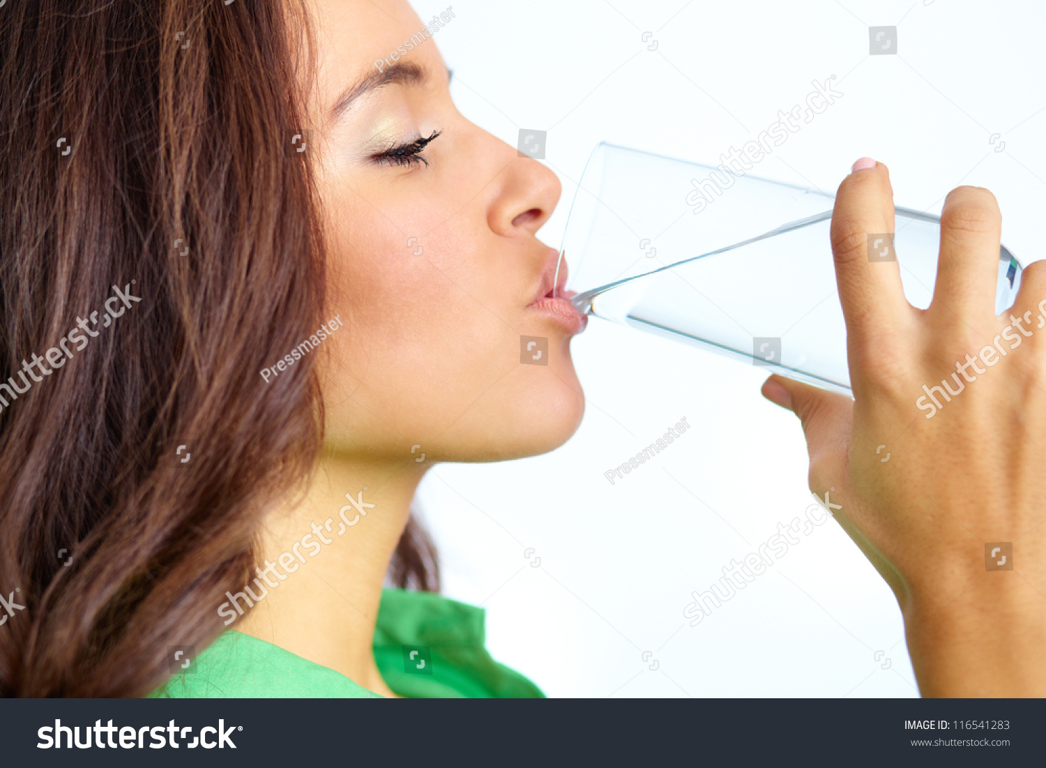 Close-up of pretty girl drinking water from glass #116541283