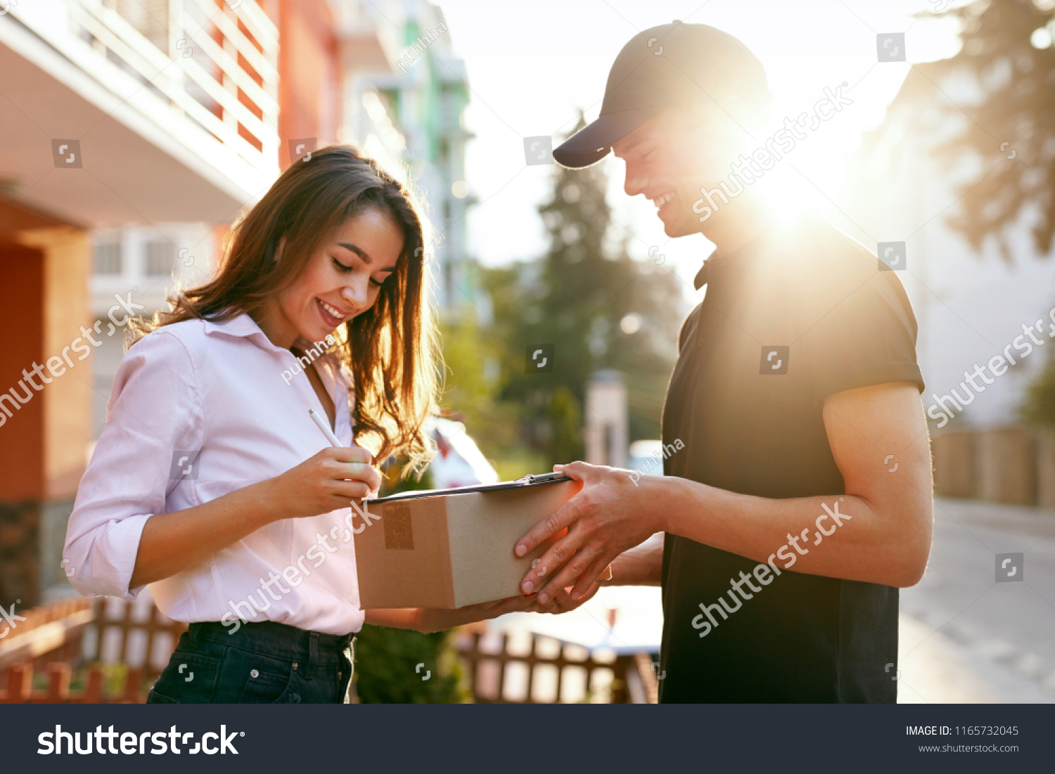 Courier Delivering Package To Woman, Client Signing Document #1165732045