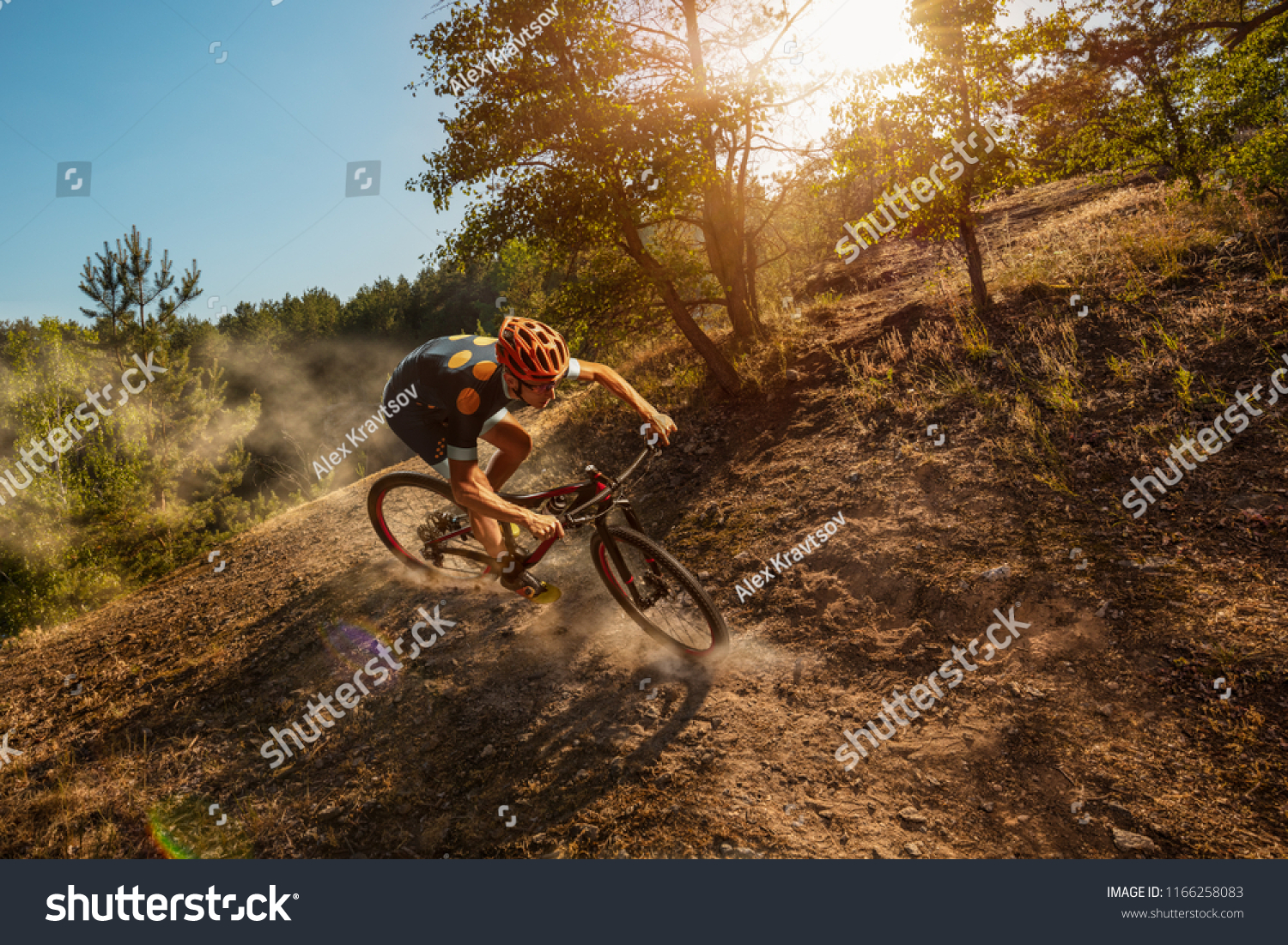 Cross-Country biker on forest trail. Male cyclist rides the rock #1166258083