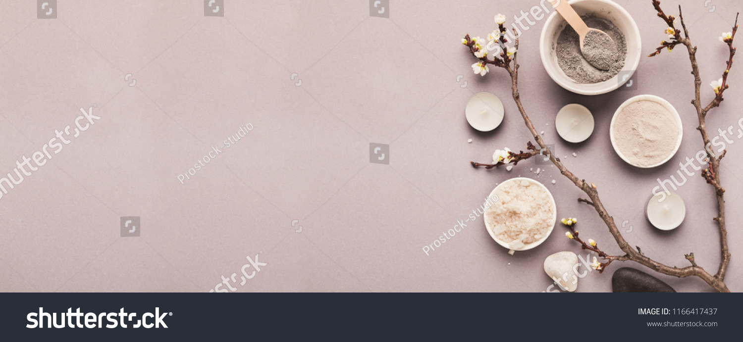 Preparing cosmetic black mask with spring flowers on gray background, copy space #1166417437