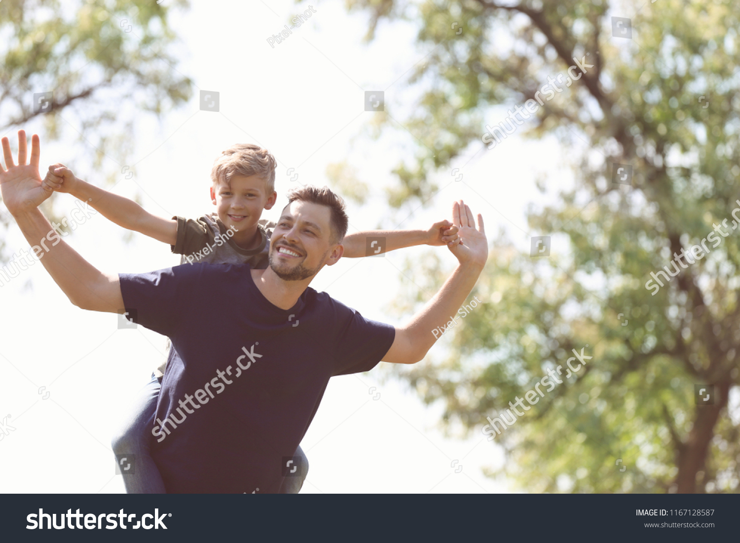 Little boy and his dad playing outdoors #1167128587