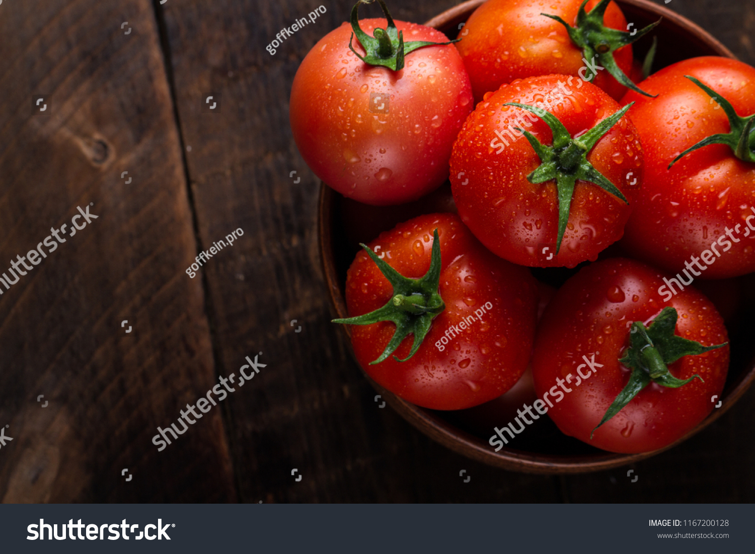 Fresh tomatoes in a plate on a dark background. Harvesting tomatoes. Top view #1167200128