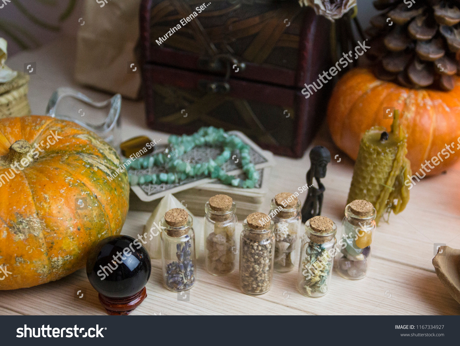 A test tube with seeds and stones, pumpkin and crystals, witchcraft, Wicca #1167334927