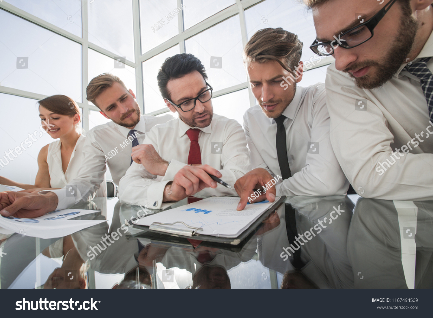 business team discussing financial documents #1167494509