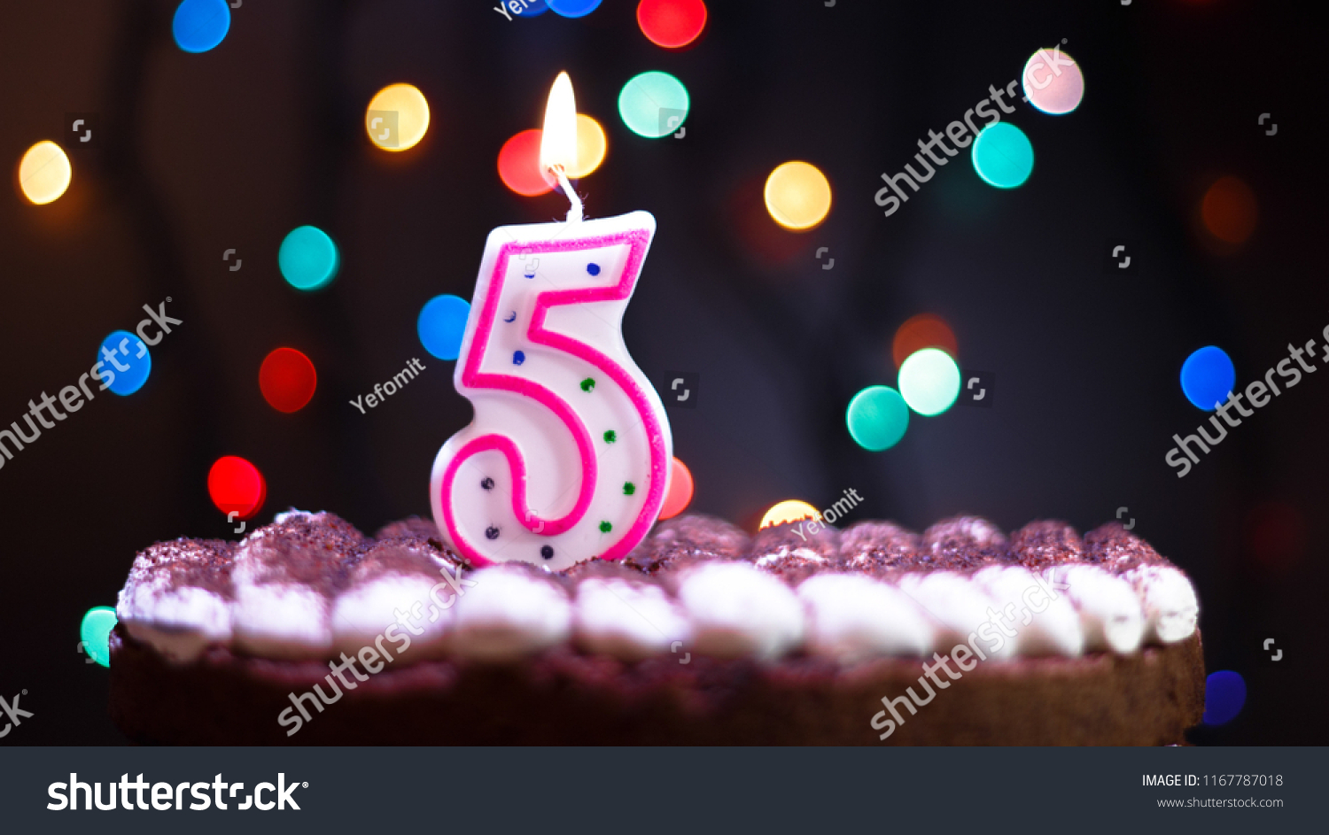 Happy Birthday.Holiday cake with candles.Birthday greetings.Greeting card.Colorful birthday candles.Five years.Growing up.Abstract colorful background.Colorful bokeh.Top view.Stop motion. #1167787018