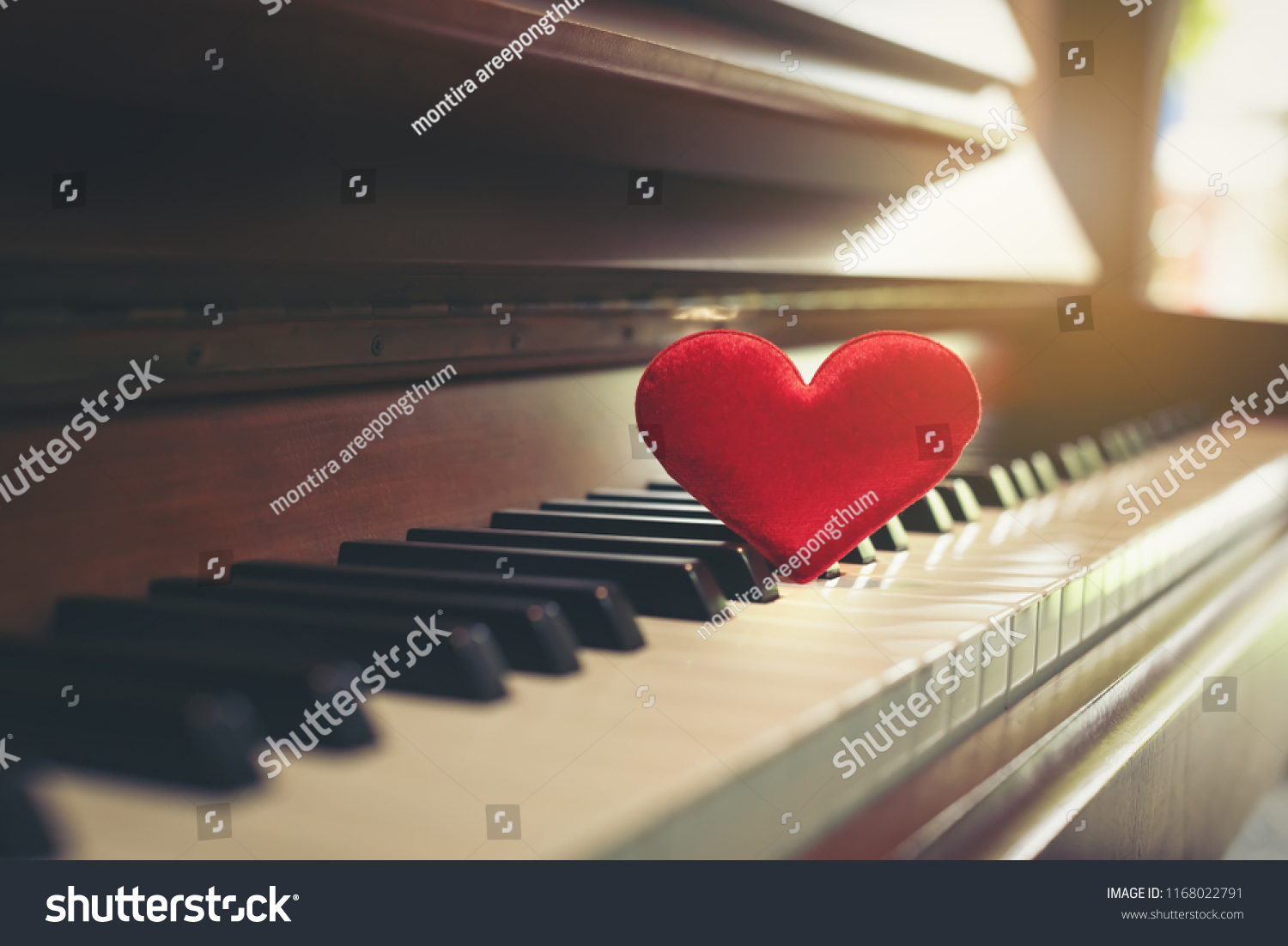 Red cartoon heart put on keyboard's piano, To tell love to learn music or to tell someone love in special day and valentine day. #1168022791