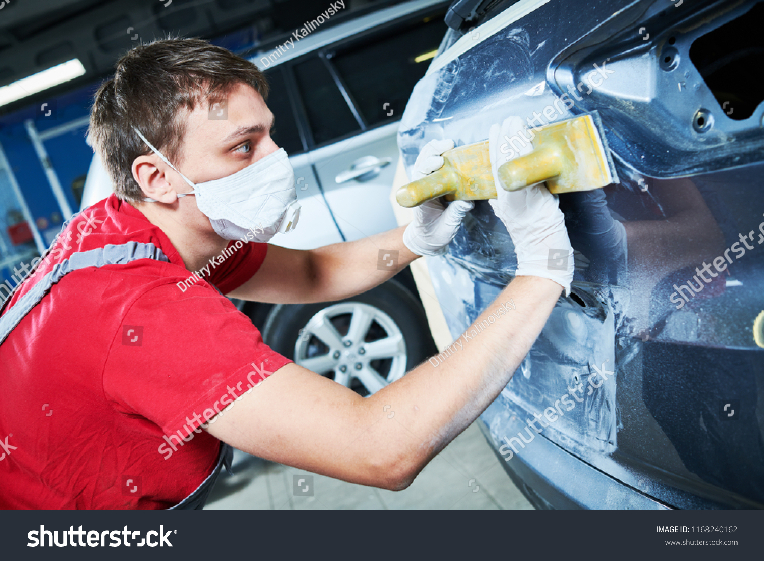 auto repairman grinding automobile body #1168240162