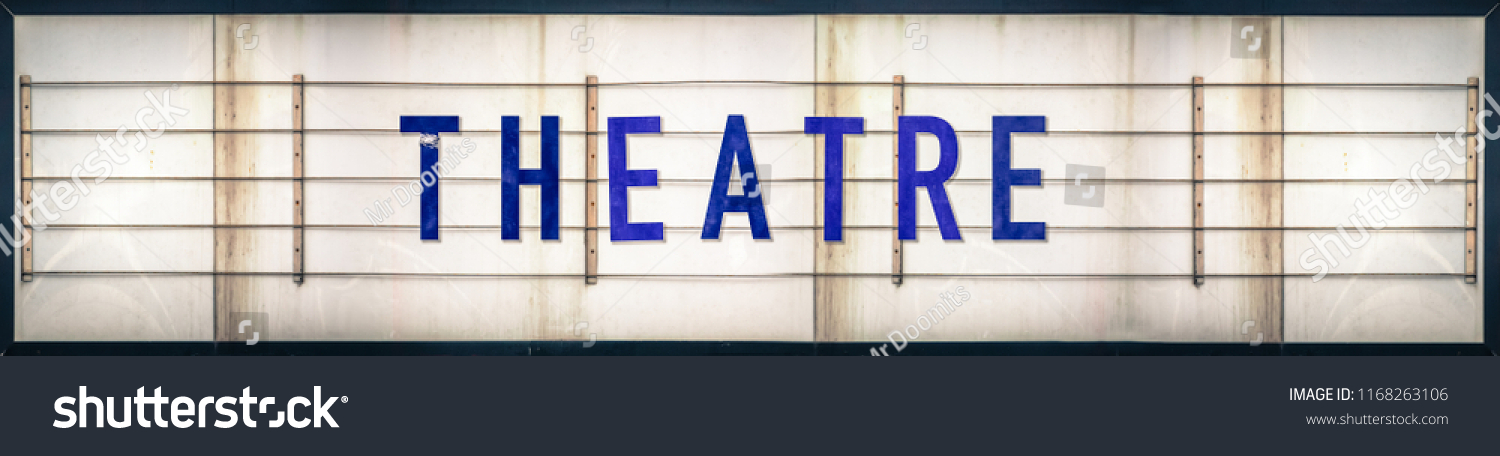 A Grungy Old Weathered Theatre Marquee Sign With Blue Letters #1168263106