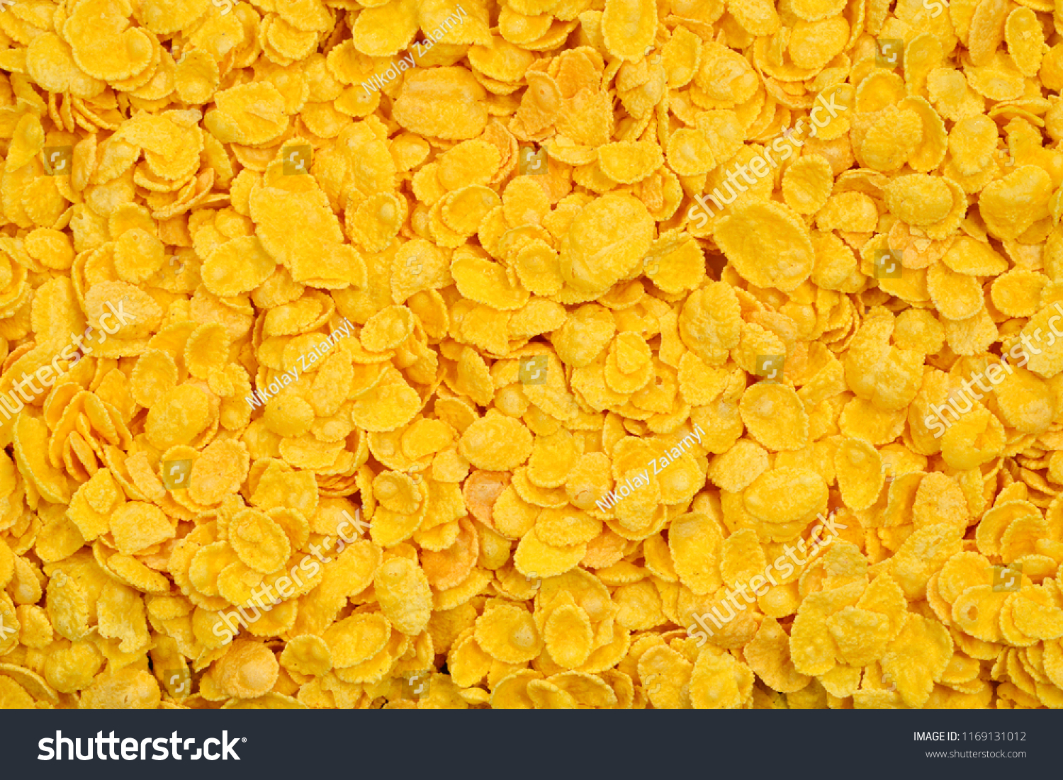 Corn-flakes background and texture. Top view. cornflake cereal box for morning breakfast. #1169131012