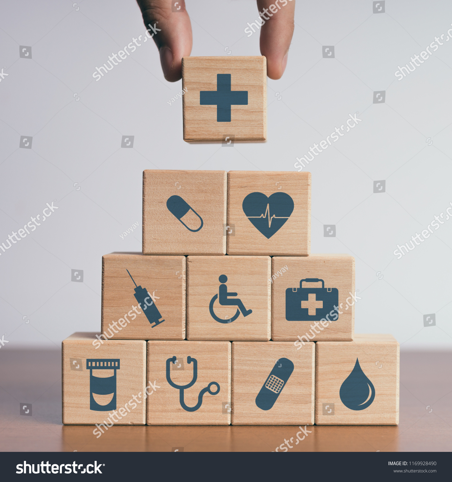 Concept of Insurance for your health, Hand hold wooden block with icon healthcare medical #1169928490